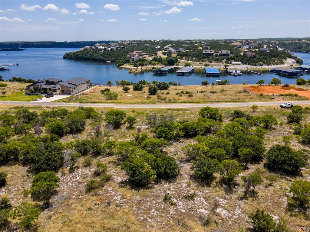 Build your dream lake home on this spacious 1.69-acre lot tucked inside the highly sought-after Gaines Bend community at Possum Kingdom Lake. This beautiful property offers lake views from the first story and ample room to design a custom retreat with privacy and character. Surrounded by scenic hills, mature trees, and native wildlife, the setting feels peaceful and secluded while still being close to the action. Enjoy access to Gaines Bend amenities, including private boat ramps, community docks, and a variety of outdoor recreation opportunities. Whether you’re planning a weekend getaway or a forever home, this lot offers the perfect foundation for lake life at its best.