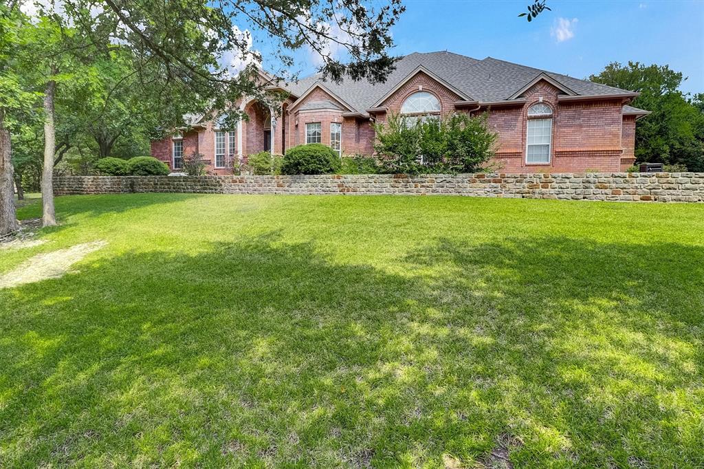 *NO CITY TAXES, New roof in 2025 and multiple areas freshly painted, Move-In Ready*
This one-of-a-kind, custom-built home sits on a spacious 1.78-acre treed lot, offering a blend of luxury, functionality, and modern conveniences. Designed with an engineered foundation supported by 67 piers, the home ensures structural integrity. Downstairs features a breathtaking living room open to the upstairs loft, 4 spacious bedrooms, walk-in closets, 3 ½  bathrooms, a flex space off the entry and a large space for a dining table  overlooking the back yard. The enormous loft upstairs plus the full bathroom and media room is perfect for hosting slumber parties for your children or short-term guests. The media room boasts a floor to ceiling motorized curtain which automatically opens to reveal the 120-inch screen, has 8 recliners, a wet bar with space for a beverage refrigerator, and is fully insulated to minimize sound transmissions. The property is equipped with a zoned HVAC system, two water heaters, an in-house vacuum system, an automated sprinkler system, and a monitored security system with smoke detectors. The oversized-extra deep 3-car garage provides space for longer vehicles, is fully insulated with two closets for ample storage and includes a built-in work bench and cabinets. Additionally, a 480 sq. ft. bricked building located at the back of the property, featuring insulation, air conditioning, storage, and a garage door opener, serves as a versatile space for hobbies or work. * This single owner, well-maintained home has never had inside pets. With more features than expected at a competitive price, this home is marketed as a dream property that exceeds expectations. The phrase “must see to appreciate” underscores its unique appeal and high-quality finishes * More than you imagined for less than you Dreamed!!