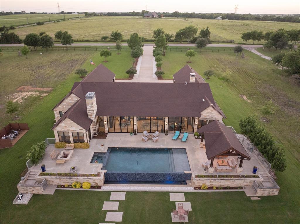 Set on over 4 acres of scenic Texas landscape, this stunning Hill Country Contemporary blends clean modern design with the natural beauty of its surroundings. Expansive windows frame breathtaking panoramic views, while the open-concept floor plan creates a seamless flow ideal for both everyday living and effortless entertaining. At the heart of the home, the chef's kitchen impresses with two oversized islands, offering abundant prep space, stylish gathering areas, and a striking focal point for the main living space.

Step outside to your own private retreat, where an infinity-edge pool appears to spill into the rolling Hill Country beyond, creating a resort-style setting unlike any other. With 4-car garage space you are provided ample room for vehicles, storage, or hobbies, adding both convenience and versatility. Thoughtfully designed to capture the essence of luxury indoor-outdoor living, this exceptional property offers sophistication, comfort, and unforgettable views in one remarkable setting.