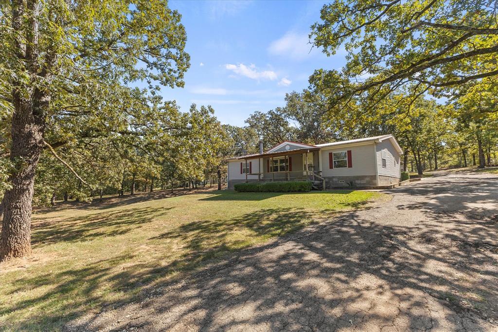 Just under 10 acres of rolling hills with gorgeous mature trees and plenty of privacy. This property offers two separate gated entrances, two manufactured homes, two carports, a storage building, and a beautiful 2-acre pond. Located near Canton Trade Days, the setting is peaceful yet convenient. The land is full of nature and wildlife, with endless possibilities for building, recreation, or investment.