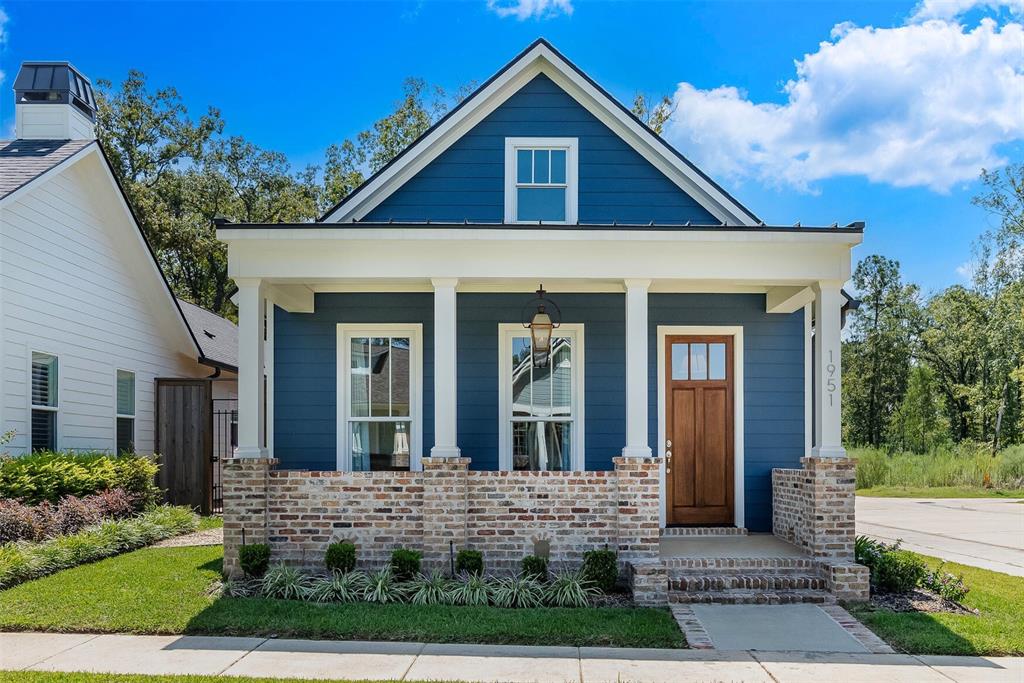 Nestled on a prized corner lot with peaceful park views, this 2023 custom cottage marries South Carolina Low Country architecture with refined modern living. Every finish was carefully chosen, every upgrade thoughtfully added, creating a home that feels as timeless as it is fresh.
At the exterior, the front porch and Country French brick parapet wall with white sand mortar lends a sense of heritage and grace. Step through a welcoming designated foyer, and the home opens into an airy living area bathed in natural light, where wide-plank oak-toned luxury flooring runs seamlessly underfoot—carpetless, effortless and elegant. The kitchen is a showcase of design and function: Miami Vena quartz countertops glisten beneath custom lighting, an island ($4k upgrade at time of construction) anchors the space, and above it all, a crystal Sputnik chandelier makes a bold, glamorous statement. A minimalist custom vent hood and gas range balance beauty with performance, while polished nickel fixtures gleam throughout, echoing the home’s cohesive palette of crisp whites and warm natural textures. The primary suite is generous in scale, with room for a sitting area, a walk-in closet and a spa-like bathroom with marble-look tile. Generously sized guest bedroom. In the guest or hall bath, a 60” Kohler alcove soaking tub promises retreat. Frameless shower doors, designer backlit mirrors and upgraded Kohler plumbing fixtures elevate every bath into a sanctuary. Charlotte Gaisford Blue Tiger wallpaper adds charm to the laundry, while custom can lighting brightens bedrooms and utility spaces. A dedicated utility room (a rare find in this plan), garage closet and a floored attic provide valuable storage. Solar screen partition ($5k upgrade) at garage. Electric car charger. This is more than a cottage—it is a curated home of character and craftsmanship. With its vista views, premium lot placement, and custom upgrades at every turn, it offers a rare opportunity to own such a special home.