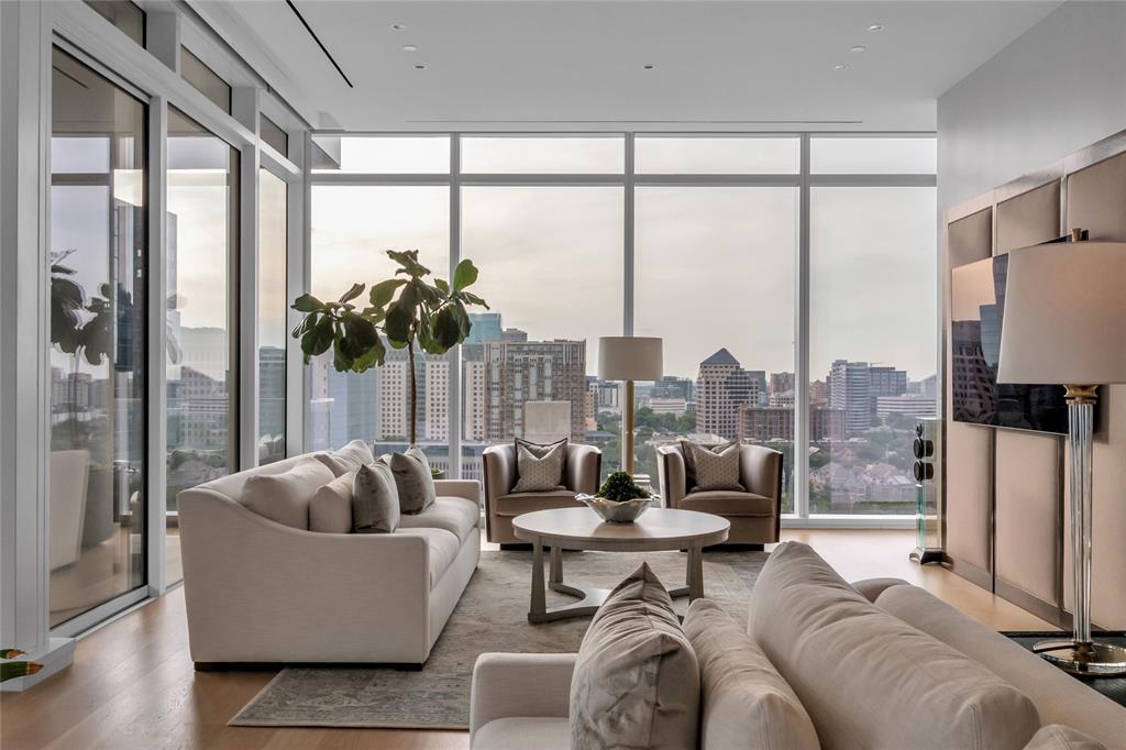 With Dallas skyline views from the 14th floor of the prestigious Hall Arts Residences in the heart of the Dallas Arts District, Unit 1402 offers elevated luxury living with 3 bedrooms, 3.1 baths, and 3,677 square feet of impeccably designed interiors. Built in 2020, this sophisticated half floor residence showcases exceptional craftsmanship and designer finishes throughout, including embossed leather walls, luxe wallpaper accents, Ornare custom closet, mirrored storage cabinetry, and expansive floor-to-ceiling windows framing the best most immersive views of Dallas, including the AT&T Performing Arts Center and Winspear Opera House. The spacious layout features a private alcove, abundant storage throughout, AV audio systems and electric window shades  already integrated, as well as a chef’s kitchen outfitted with Miele refrigeration, wine storage, and premium Gaggenau appliances including a warming drawer, oven, and microwave.
The serene primary suite offers plush carpeting, generous custom storage with built-in dividers and drawers, and a spa-inspired bath with refined finishes. It is also tucked away from the secondary bedrooms. The secondary bedrooms each feature en-suite baths with sleek stand-up showers. Residents enjoy access to Hall Arts Hotel-level amenities including concierge services, resort-style pool and hot tub, putting green, fitness center, pet spa and dog wash station, wine room, massage treatment room, a catering kitchen, boardroom, outdoor grilling areas, game room, and more! This residence is move-in ready and available to be purchased furnished, it delivers an unmatched lock-and-leave lifestyle in one of Dallas’ most exclusive luxury towers and in the Arts District with great walkability to some of the best restaurants and culture.