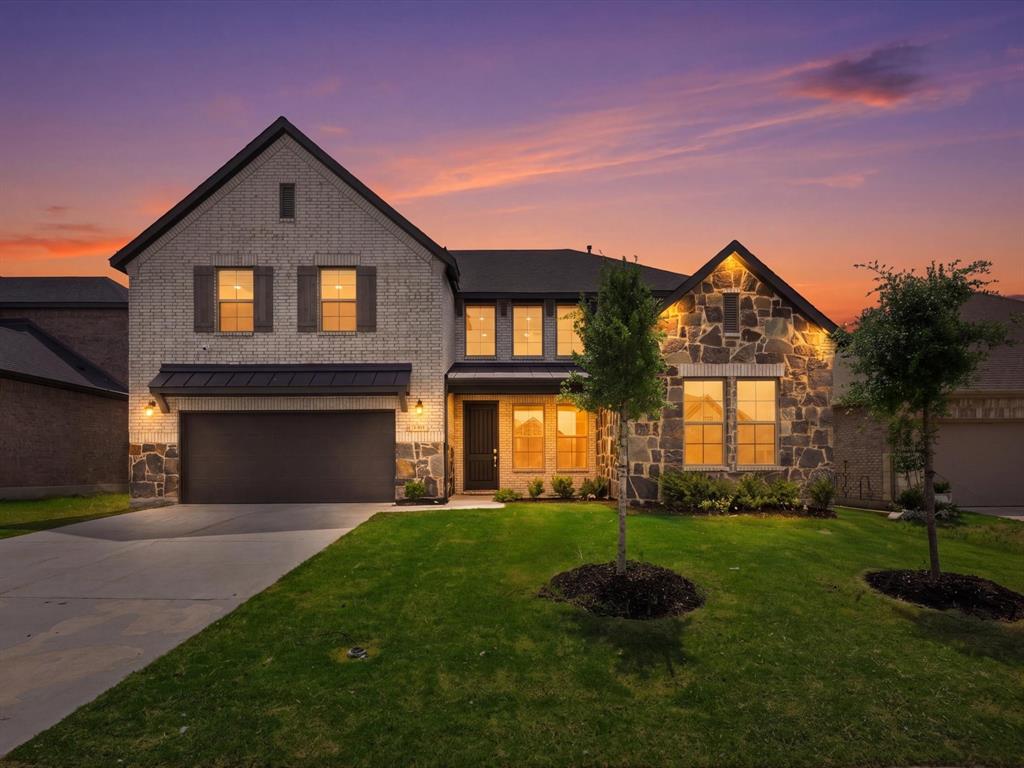 Located in a vibrant Hickory Creek community, this home offers the perfect blend of lifestyle and convenience. Enjoy neighborhood amenities including a community pool, playground, and scenic walking trails, along with exclusive access to Sycamore Bend Park, where you’ll find lake access, camping, and miles of nature trails just minutes away.

Step inside to a light-filled, open-concept design with soaring ceilings and expansive sightlines that immediately make the home feel both spacious and inviting. The heart of the home is the stunning kitchen, featuring a large center island, quartz countertops, stainless steel appliances, a 5 burner gas range, convection oven, and a walk-in pantry. all complemented by sleek, modern finishes, crisp white cabinetry, designer lighting, and a striking backsplash. The space flows seamlessly into the living and dining areas, making it ideal for entertaining.

the first floor includes a spacious primary suite along with a private multi-generational suite complete with its own full bathroom, ideal for guests or extended family.

The primary suite is a true retreat, featuring a bay window, a spa-like bathroom with a soaking tub, dual vanities, and a large walk-in closet that conveniently connects directly to the laundry room.

Upstairs, you’ll find a large game room, dedicated media room, and three additional bedrooms, offering plenty of space for both relaxation and functionality.

Step outside to a covered patio overlooking a generously sized backyard, perfect for entertaining, play, or simply enjoying quiet evenings at home. This home truly combines modern design, thoughtful layout, and an unbeatable lifestyle location, ready to welcome you home.