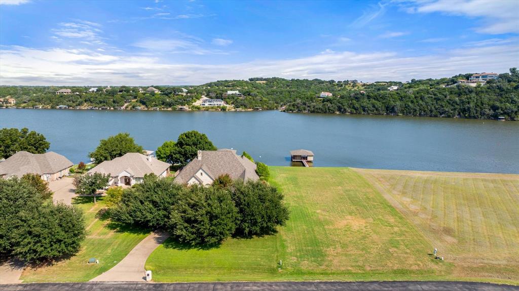 Mainbody Waterfront Lot with Boat Dock
Experience the best of lakefront living on this beautiful mainbody waterfront lot offering wide-open views and easy water access on Lake Granbury. Nestled in a quiet neighborhood surrounded by upscale homes, this property features a private covered boat dock with a boat lift and two jet ski lifts, perfect for fishing, boating, or relaxing by the water.
With its gentle slope to the shoreline and deep-water location, this homesite provides an ideal setting to build your dream lake house or weekend retreat. Enjoy morning coffee overlooking the sparkling water, host sunset gatherings on the dock, or spend the day cruising from your own backyard.
Conveniently located near shopping, dining, and historic downtown Granbury, this property combines tranquility and accessibility—offering a rare opportunity to own one of the most desirable waterfront lots on the lake.