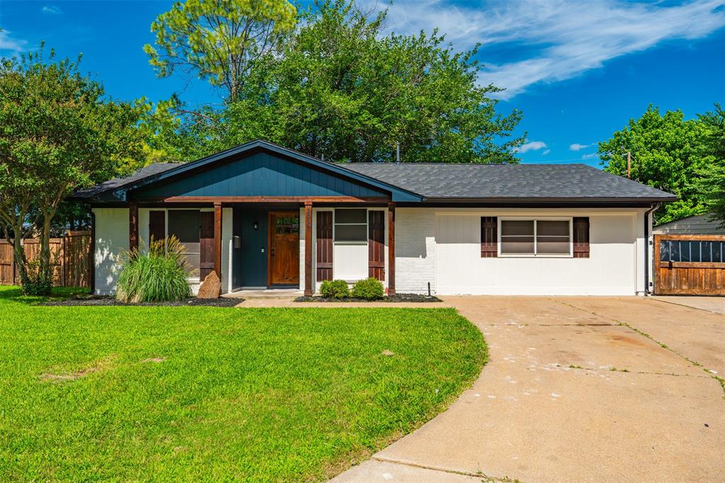Move right into this fully renovated single-story home that blends modern updates with timeless charm. From the moment you arrive, the fresh exterior, crisp landscaping, and inviting covered front porch set the tone for what's inside. Step into a bright, open-concept living space featuring soaring vaulted ceilings, striking exposed wood beams, and rich wood-look flooring throughout. Elegant sliding barn doors into the fourth bedroom or office add character while flooding the home with natural light. The stunning kitchen impresses with two-tone cabinetry, subway tile backsplash, butcher block counters, stainless appliances, and a farmhouse sink. This rare four-bedroom layout includes a private primary suite complete with an ensuite bath boasting dual vanities, designer fixtures, a tiled walk-in shower, and a spacious walk-in closet with built-in shelving. Additional bedrooms offer generous space and stylish built-ins, while a second full bath features a tiled tub and shower combo. Outside, the oversized fenced lot is a true standout with mature shade trees, a sprawling lawn, and plenty of room to play, garden, or relax. A separate detached two-car garage provides excellent storage, workshop potential, or parking. Thoughtfully updated and truly turn-key, this one checks all the boxes.