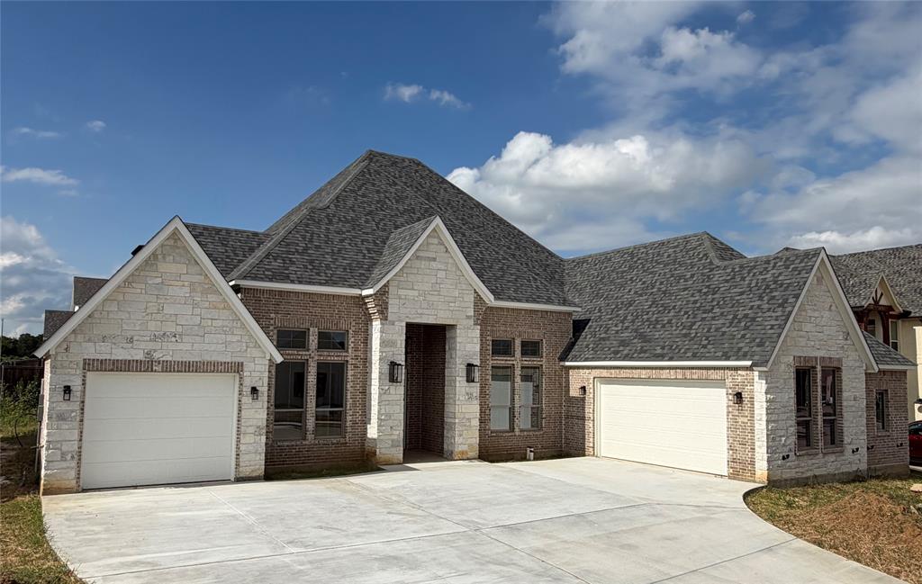 Welcome to this exceptional 4-bedroom, 3.5-bath new construction home in the highly sought-after Thomas Crossing community, home to Southern Oaks Golf Course. Thoughtfully designed with custom features throughout, this residence combines timeless elegance with modern functionality. Step inside to find wood floors throughout main living areas and primary bedroom, designer lighting fixtures, and upgraded tile and flooring that elevate every space. The heart of the home is the expansive kitchen, featuring a striking white oak island, premium finishes, and a spacious walk-in pantry with built-ins which are ideal for effortless organization. A private study offers the perfect work from home retreat. The luxurious primary suite and additional bedrooms provide ample space for relaxation. Step outside to the oversized covered patio with a cozy fireplace - a dream setting for year round entertaining. The conveniently located powder bath doubles as a future pool bath, making outdoor living even more seamless. Additional highlights include a 3-car garage with abundant storage space. This home is truly a must-see for those seeking elevated design, quality craftsmanship, and the perfect blend of comfort and luxury! Property is ready to go under contract and will be move-in ready in August 2026!