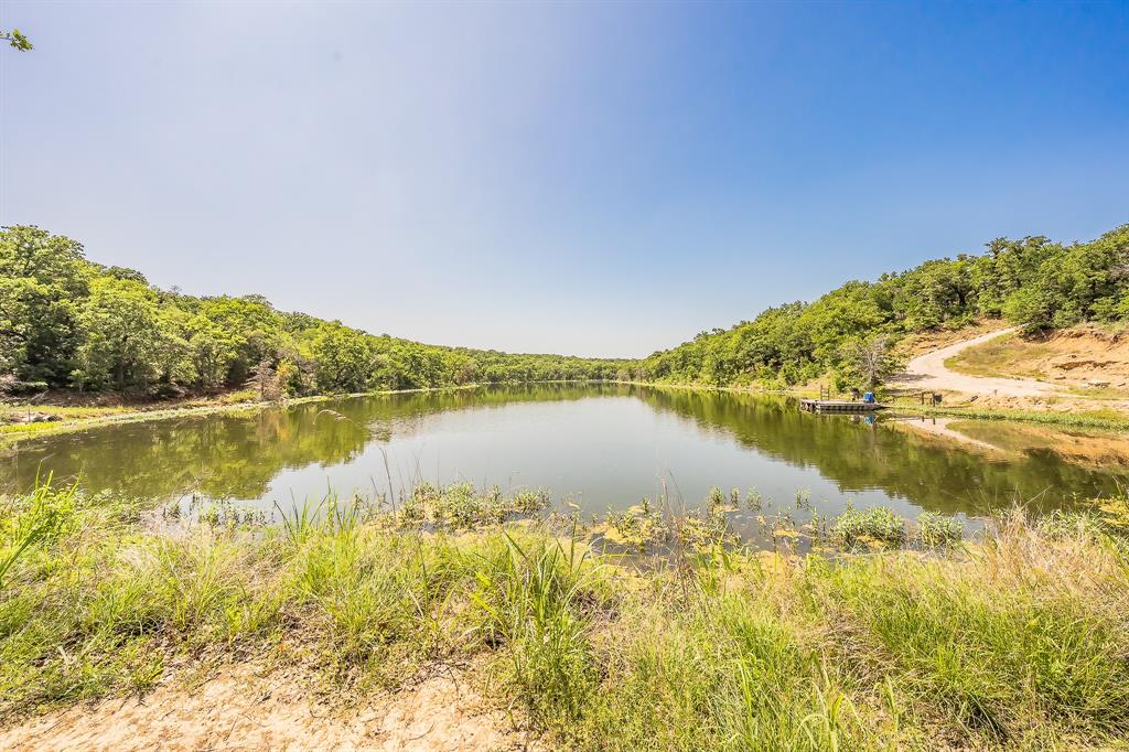 Rare investment opportunity!!  Hwy I-20 access road frontage just miles from the Ric Williamson Memorial Hwy and the rapidly developing west Weatherford corridor.  Exceptional 60 acres only twelve miles to Weatherford, five miles to Millsap and two miles from the town of Brock.  Many elevation changes from level to rolling with a beautiful private eight acre lake, a fisherman's dream!  Mature trees and massive boulder rocks are scattered throughout to beautify this scenic oasis.  The land has many development opportunities and potential for commercial usage with access road frontage, high visibility and a variation of terrain.  This property could potentially be subdivided into smaller acreage homesites, RV resort type of development or even a winery or craft venue!  The water supply has been put in place and run to the north end of the property allowing for the initial savings to a buyer.  Bring your imagination to this one of a kind property!