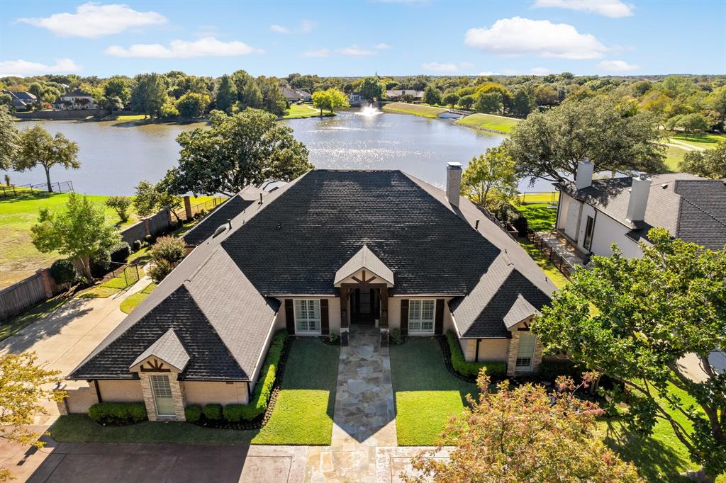 Seldom do we say that a home has it all, but this rare find on over half an acre in Willow Bend Lakes has a combination of spaces and upgrades that make it a must-see! The great room’s wall of windows showcases a stunning view of the lake and your personal outdoor oasis. Floor-to-ceiling fireplace, skylights, and exposed wood beams in the great room bring warmth to the open area. The kitchen’s large island provides seating and tons of storage; the cabinetry and custom backsplash are a wonderful accent to the other bright tones. Owners’ retreat has a seating area and the ensuite bath has dual vanities, dual closets, a garden tub, and a stand-alone shower. The right side of the house has 3 other bedrooms, two at the front that share a full bath and one in the back that shares a full bath with the family room. These features paired with the waterfront views create an experience unlike anything else in the area!
