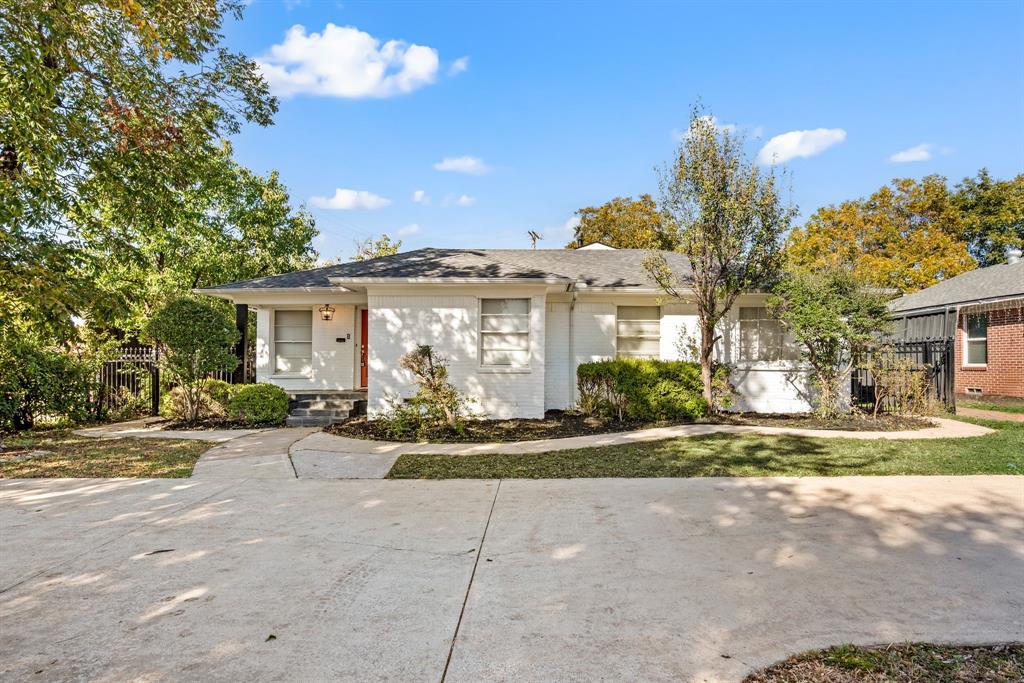 Welcome to this beautifully updated Dallas gem, where classic character and modern sophistication blend seamlessly. From the moment you arrive, the crisp white brick exterior and vibrant red front door create a warm and welcoming first impression, setting the tone for the charm within. Step inside to discover a light-filled living area adorned with soft neutral tones, crown molding, and rich hardwood floors.  The updated kitchen is a true centerpiece — showcasing butcher block countertops, stainless steel appliances, open shelving, and custom cabinetry with vintage-style hardware. A cozy breakfast nook with built-ins and designer wallpaper provides a stylish spot to enjoy your morning coffee. The home’s elegant hallway features timeless lighting and glass sliding doors that lead to a covered patio overlooking the private backyard. The spacious primary suite offers a calming escape with large windows, warm wood tones, and sophisticated lighting. The ensuite bath exudes spa-like luxury with a marble-tiled shower, a clawfoot soaking tub, and gold-accented fixtures that pair beautifully with dual vanities and crystal chandeliers. Completing the primary wing is a stunning custom closet, featuring abundant built-ins, a center island with mirrored top, and a statement chandelier. Additional highlights include a large utility room with extra storage, multiple flexible living spaces, and a fenced backyard perfect for entertaining or relaxing outdoors. Perfectly located in north Dallas, this home offers a rare combination of character, craftsmanship, and modern convenience. Schedule your showing today!