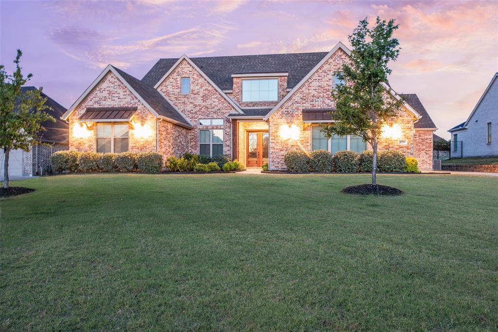 Located in Brockdale Estates within Lovejoy ISD, this barely lived in, single-story home offers a vaulted ceiling design, and an open-concept layout with 4 bedrooms, 4 bathrooms, a study with coffered ceiling, and a primary bedroom with access to the laundry room from the closet.  The dedicated media room features a 110' backlit screen paired with 4k enabled Epson projector, 7 speaker surround with Denon system and tiered seating for a true home theater experience. The Carleigh floorplan was built on an east facing lot in 2022 by Our Country Homes using Zip system wall sheathing at construction.  The oversized kitchen features Thermador appliances, including 2 Thermador dishwashers, Dacor refrigerator and freezer, a pot filler, leathered granite countertops, and a quartzite island, providing expanded prep space and storage. The layout connects kitchen, living, and dining areas for functional flow, with dedicated spaces for media and work-from-home use. Additional features include wood floors throughout main living, enhanced lighting and hardware features, custom shades including black out remote controlled in the primary suite. Other features include an integrated Alexa-enabled audio system in kitchen and living areas, Pella sliding door opens to the covered back patio with fireplace, whole house water softener, three-car garage equipped with 40 amp EV charging capability.  Fast and easy access to Lake Lavon and Brockdale Park from here for a quick walk or to take the boat out!