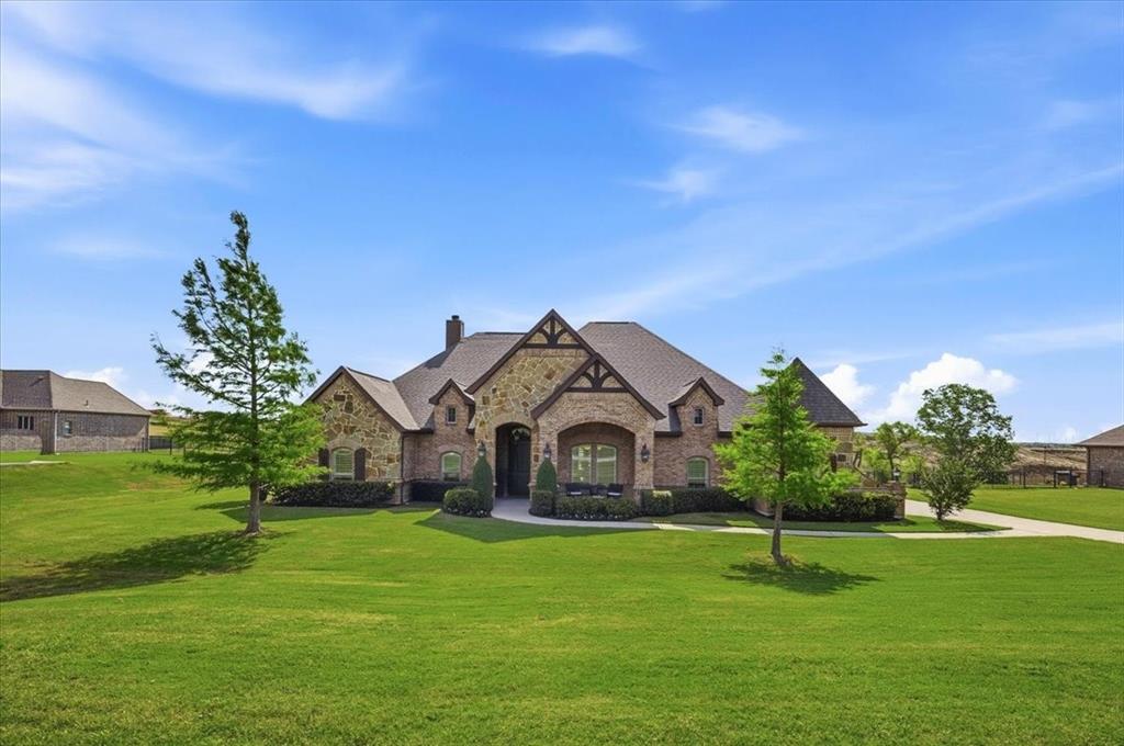 Set on a full acre in the gated enclave of Lago Vista at Bonds Ranch, near Eagle Mountain Lake, this impeccably maintained Ashlyn Homes residence blends privacy, scale, and thoughtful design.

Built in 2015 the property sits on a a little over an acre with views, creating a rare sense of space and seclusion. Inside, architectural details immediately stand out—graceful archways, cased windows with shutters, wood beams, and a striking stone fireplace anchor the main living area, while natural light flows effortlessly throughout.

The heart of the home is a true entertainer’s kitchen, centered around an impressive 10x6 island with abundant storage. Outfitted with stainless steel appliances, a over-sized walk-in pantry, butler’s pantry with wine bar, and a charming breakfast nook, it seamlessly connects to both the formal dining room with raised ceiling and the inviting living space.

A smart, split-bedroom layout offers both functionality and privacy. Two secondary bedrooms share a Jack-and-Jill bath with granite finishes, framed mirrors, and built-ins, while a separate bonus-flex room anchors the secondary wing. A dedicated office with glass doors and closet provides flexibility for work, additional living or bedroom.

The private primary suite is a true retreat, featuring a coffered ceiling, brand-new carpet (2026), and a spa-like bath complete with separate vanities—including a seated vanity—dual showers, garden tub, and an expansive walk-in closet with floor-to-ceiling storage. Direct access to the laundry room adds everyday convenience and privacy.

A rare opportunity to own a meticulously cared-for property with space to breathe—inside and out.