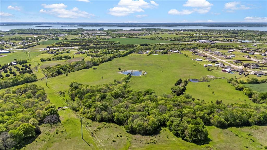 RARE OPPORTUNITY! APPROXIMATELY 2 MILES FROM LAKE LAVON! ALL INVESTORS, RANCH ENTHUSIASTS, AND DEVELOPERS MUST SEE! Multiple living quarters with pool, workshop, garage, and barn. 7191 square feet under roof not including the barn! Current agricultural exemption on all parcels. Parcels located in the county with no restrictions. Home is cozy with good bones, and with renovation; an original farmhouse could be modernized and evolve into an extraordinary retreat! Commercial grade shop with living quarters above and below currently used as a nice man cave. Rent the other 1100 square foot home for additional income or provide living quarter for a ranch hand! Approximate 100-150 foot tall cellular tower on property and is granted a permanent easement. Current owners state that tower crew maintenance is minimal. A far north entrance and alleyway could possibly be developed for privacy and easy access, as the tower sits near the north property line. Over 57 acres here so the possibilities are endless! All information to be verified by buyer and or buyer's agent.  All appointments must be scheduled 24 hour in advance. Please do not visit property unannounced and block driveways as there are some shop work and agricultural operations going on daily. Thank you for viewing this property.