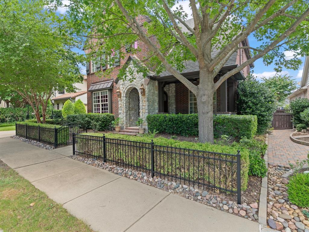 Welcome to this beautifully maintained home in the highly sought-after Tucker Hill community, just a short stroll from Founder's Square. Blending timeless charm with thoughtful upgrades, this 4-bedroom home offers an open concept layout designed for both comfortable everyday living and effortless entertaining. The spacious first-floor primary suite provides a private retreat with a luxurious bath featuring a walk-in shower with built-in seat, while upstairs you'll find three additional bedrooms, a game room, and a dedicated media room complete with projector, screen and surround sound wiring. A private office with custom built-ins creates the perfect work from home space. The heart of the home is the beautifully appointed kitchen featuring quartz and granite countertops, a striking Daltile stacked stone backsplash, GE Profile double ovens, cooktop and microwave, Bosch dishwasher, and abundant prep space. Rich crown molding, transom windows, cased openings, and a stunning stacked stone fireplace add warmth and character throughout the main living areas. Outdoor living is impressive with an oversized covered patio featuring nonskid wood-look porcelain tile, a pergola, and a brick fireplace makig an ideal setting for entertaining or relaxing year-round. Music lovers will appreciate whole-home audio wiring serving the living room, primary bedroom and back porch. Practical features include an oversized utility room with a convenient side entrance and utility sink, storage cubbies, generous storage throughout the house including large closets and under-stair storage, an insulated garage door, and an oversized two-car garage with epoxy floor. Built in 2011 and meticulously cared for by owner, it also features freshly painted exterior trim and iron fencing (2026). Located in acclaimed Prosper ISD this exceptional home offers the perfect combination of quality craftsmanship, thoughtful design, and an unbeatable Tucker Hill lifestyle. Just a block away from pool and clubhouse
