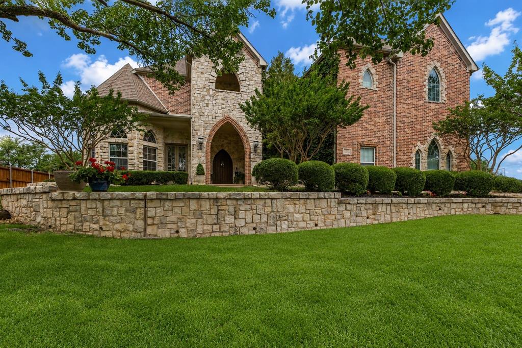 Located on .61 acres in gated Hills of Breckinridge, this custom home showcases a spectacular European-style exterior with striking architectural details. Find hand-scraped hardwood floors, neutral paint tones, dual staircases, cathedral-inspired windows, a dramatic gothic-style heavy wood front door, and abundant natural light throughout. The expansive backyard is designed for entertaining with a resort-style pool featuring a waterfall, rock accents, and an oversized spa. A spacious kitchen offers granite countertops, double ovens, built-in refrigerator, island, breakfast bar, an adjacent wet bar, and open flow to one main living area that services the first level. Wind down in the remodeled upstairs Primary Retreat, featuring a cozy fireplace, oversized shower, dual vanities, a private balcony overlooking the pool, and a large walk-in closet with direct access to the utility room. Upstairs, the Media Room and adjoining Game Room are currently utilized as an additional bedroom suite, while an 8' x 9' bonus room provides flexibility for a fitness room or secondary office. A private Guest Suite downstairs with an ensuite bath offers direct pool access. The entry to the oversized 3-car garage includes a mudroom space and convenient half bath. The backyard is built for entertaining and unwinding alike—a freeform lagoon pool with a natural boulder waterfall and oversized spa, plus a covered patio perfect for alfresco dining and enjoying spectacular sunset views. The quiet, gated neighborhood features a private pond with its own walking trail and is conveniently located near three golf courses at Firewheel. Adjacent to 400+ acre Breckinridge Park, residents enjoy access to 7+ miles of hike-and-bike trails, scenic nature paths, soccer fields, a disc golf course, and playgrounds. Find great restaurants and conveniences at CityLine, along with shopping and dining in Murphy and the revitalized downtown districts of Plano and Garland.