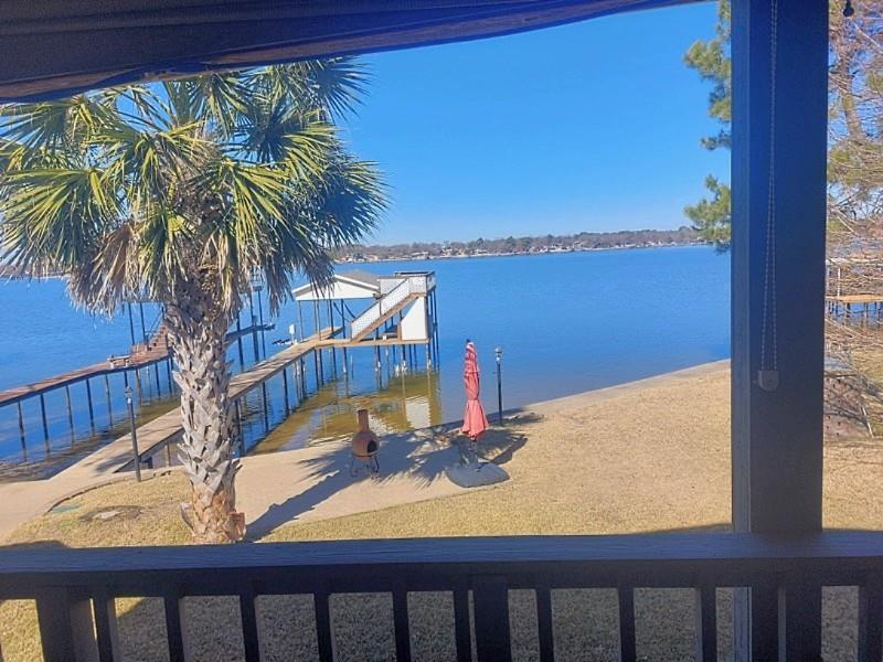 **MOTIVATED SELLERS!!** IF YOU'VE ALWAYS WANTED THAT MILLION $ WATERFRONT VIEW WITHOUT THE PRICETAG, THIS IS THE HOUSE FOR YOU!  Sellers will contribute $7,500.00 towards closing costs! This well-maintained home has it all! With 3 oversized bedrooms everyone will have room to enjoy.  Each bedroom also has its own bathroom plus an additional half bath for guests to use!  Relax by the fire in the spacious living room while you enjoy the views of the lake! Or head outside and enjoy them from the 30' deck!  The home boasts multiple places for fun, relaxation, and of course fishing!  There is deep water at the end of the boat dock so you can enjoy your time on your boat longer when the lake is low!  There is ample storage throughout the house, multiple closets and even a basement and a tool shed!  Feel like exercising? Head out to the exercise room as the workout equipment stays!  The well-appointed kitchen features granite counters, custom cabinetry, and even a wine rack!  There is ample parking so there's room for everyone!  The roof is approximately 4 years old and both HVAC units are less than 5 years old.  The home is move in ready, make it yours so you can start living the 'lake life' and enjoy all the many features this home has to offer!