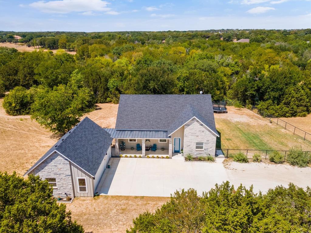 Chic modern farmhouse with industrial flare, located on 2 acres in the gated subdivision of Blue Branch Ranch. Pipe fencing with no-climb, cross fenced & complete with a horse stall. Cozy 3-2 house boasts tall ceilings with 8' doors, vinyl windows, quad patio doors, solid wood trim thru-out & foam insulation. Comfortable open concept, spacious & perfect for entertaining. Kitchen features ice machine & pot filler. Start planning your charcuterie board ideas to enjoy with your family & friends. 3rd bedroom would make a great office or workout room. Relaxing back patio which is peaceful, tranquil & very private. Just minutes to lake access on Lipan Hwy & minutes to downtown Granbury. About 20 min from Weatherford. Easy access to Tin Top Hwy, Lipan Hwy, Loop 567 & Hwy 51. Make this YOUR home sweet home! Bring your horse or up to two livestock & they will love it too!