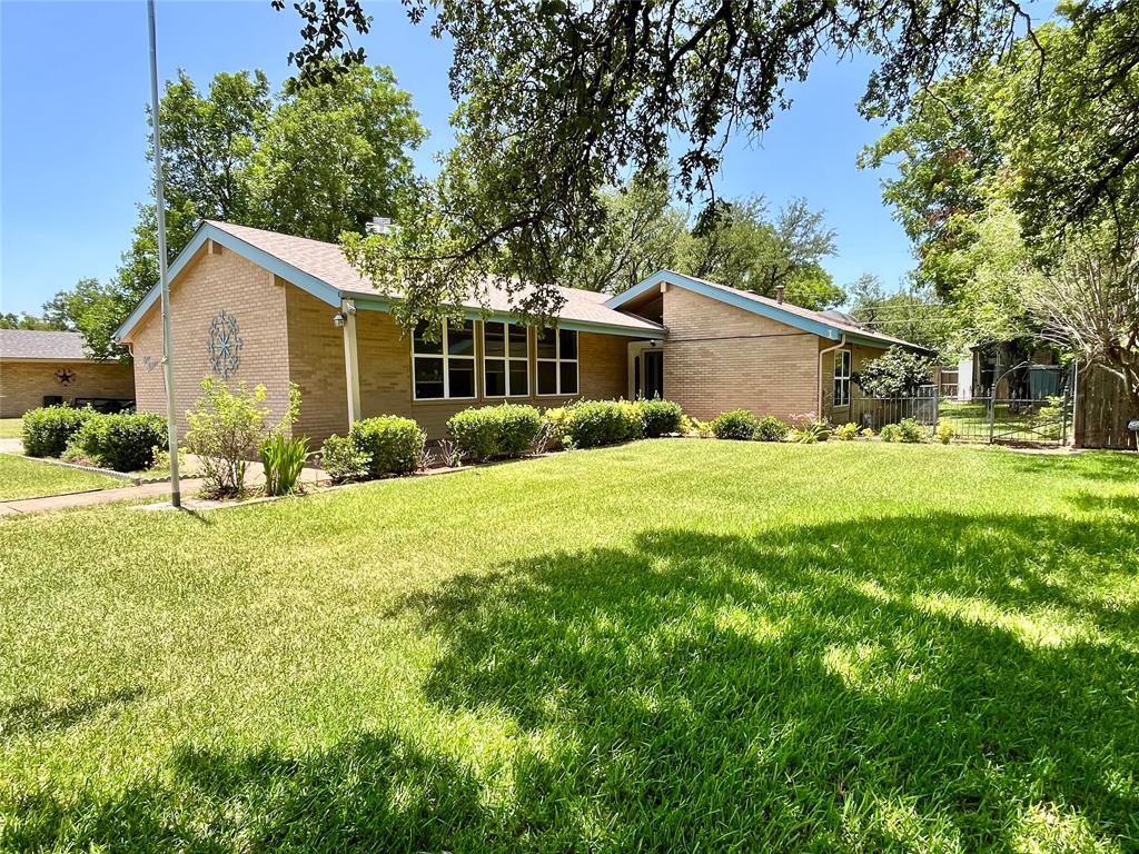 Nestled on a spacious 100' x 140' lot shaded by beautiful mature oak trees, this well-maintained 2-bedroom, 2-bath home offers 1,936 square feet of comfortable living space in a desirable Hamilton neighborhood. The inviting living area features a gas fireplace, creating a warm and welcoming atmosphere, while the kitchen is equipped with a gas range and includes the refrigerator. A large glass-enclosed patio provides additional living and entertaining space, perfect for enjoying the outdoors year-round. The property is enhanced by a sprinkler system supplied by a water well, helping maintain the lush landscape efficiently. Additional amenities include a storage building, attached 2-car garage with opener, approximately 5-year-old roof, and approximately 2-year-old central heat and air system. Combining thoughtful updates, functional features, and established shade trees, this property is ready for its next owner to enjoy.