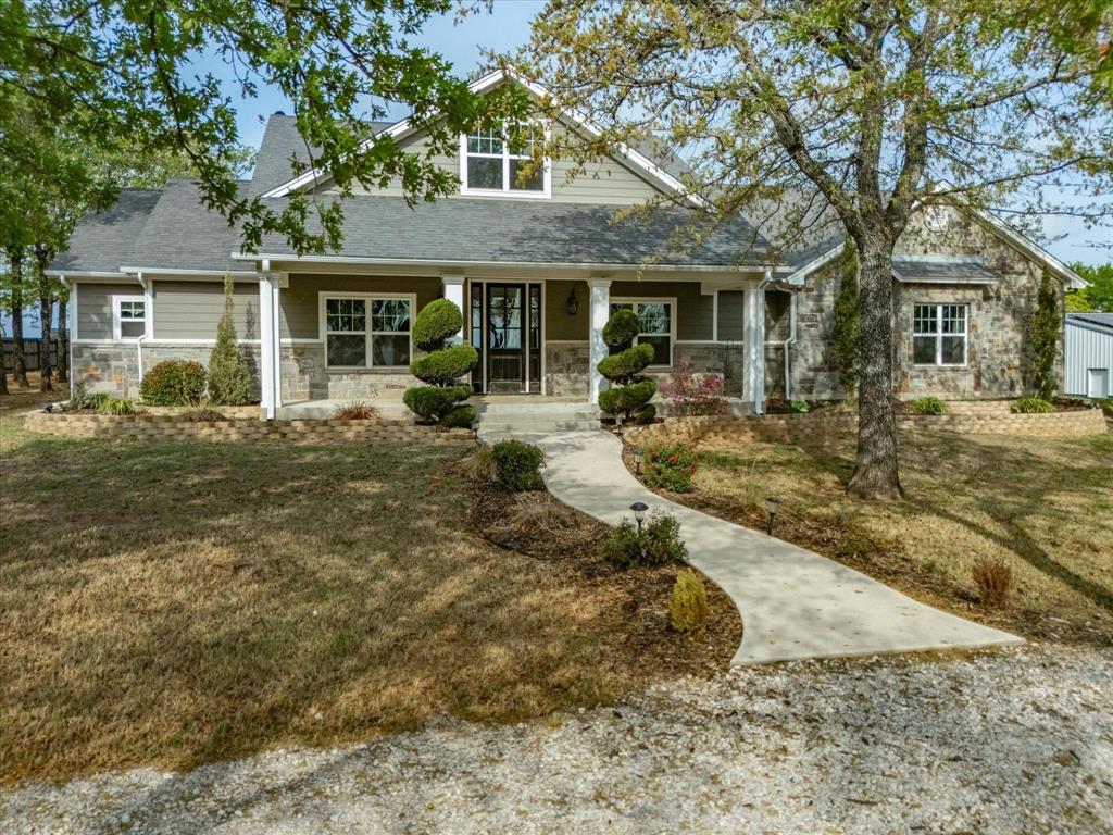 NEW ROOF by June 2026!!!Experience peaceful country living on this beautiful 3-acre property located just outside of city limits with a short and convenient drive to Highway 287 for commute. This stunning home offers engineered hardwood flooring and soaring 20-foot ceilings that create a grand, open feel throughout the main living space. The living room features custom built-in cabinets, adding both style and functionality.  The kitchen is equipped with granite countertops and ample space for cooking and gathering. Upstairs, a versatile bonus room overlooks scenic Amon G. Carter Lake, offering the perfect space for a game room, office, or additional living area.  All windows on the back of the property enjoy Amon G Carter view!  Enjoy the benefits of energy efficiency with installed solar panels that cover most months’ electricity usage. Outdoors, you’ll find a 30x40 insulated shop complete with electricity and two overhead doors—ideal for hobbies, storage, or workspace needs and garden space fenced as well.  With plenty of room to relax, entertain, and take in the lake views from the back of the property, this home offers the perfect blend of comfort, functionality, and country charm.