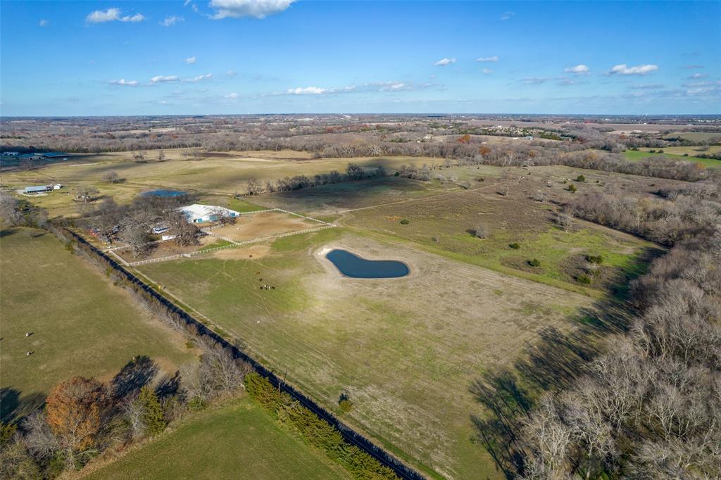 Imagine sitting on your spacious front porch, watching the sun setting over your 63 acres in Anna. This amazing ranch has a large 38-stall barn, indoor riding arena, private stud stalls, large pond, is completely fenced and cross fenced, and has other great amenities. The ranch house has 3 bedrooms and and 2 full baths along with newly updated stainless steal appliance and granite countertops in the kitchen. Plus, the property is within minutes of the recently widened Highway 121. Currently, the property is a horse rescue and sanctuary and is the home to many senior horses. It also has a dog rescue with a training and boarding operations. This property to could make a great cattle or horse ranch or investment property with the quickly growing city of Melissa just minutes away! Please know that property is in a floodplain, but it is not in a floodway - confirmed by FEMA via their floodway maps (viewed in the pictures).