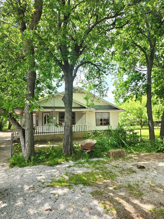 Charming vintage farmhouse nestled in the heart of Krum, Texas, ready for your personal touch! Located in a well-established neighborhood filled with mature trees and plenty of shade, this property offers the perfect setting for peaceful country living with a nostalgic feel. This 3-bedroom, 2-bath home sits on a spacious lot featuring a large backyard with endless potential—whether you envision building a shop, adding a guest house, or creating your own outdoor oasis. Full of character and opportunity, this estate property is being offered priced to sell, per the family—making it an incredible opportunity for buyers looking for a fixer-upper or a place to truly make their own. With a little love, this home could be transformed into an absolutely adorable dream property. Don’t miss your chance to turn this hidden gem into something truly special!