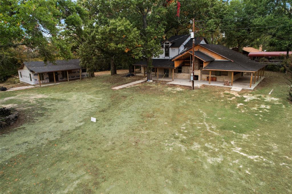 Want to build a gorgeous home on 2 acres but not sure where to get started? This home is perfect for you! Construction was started for a main house estimated at 2,700 sq ft and a guest house estimated at 1,400 sq ft on almost 3 acres. New roof put on in May of 2023. The property has beautiful mature trees and a pond dug out in the front. Minutes from Cedar Creek Lake to enjoy the day! There are so many ways you could finish out this property to make it your perfect dream home! Make this the home for you and you'll be able to enjoy that patio and fireplace while drinking your coffee in the mornings soon!