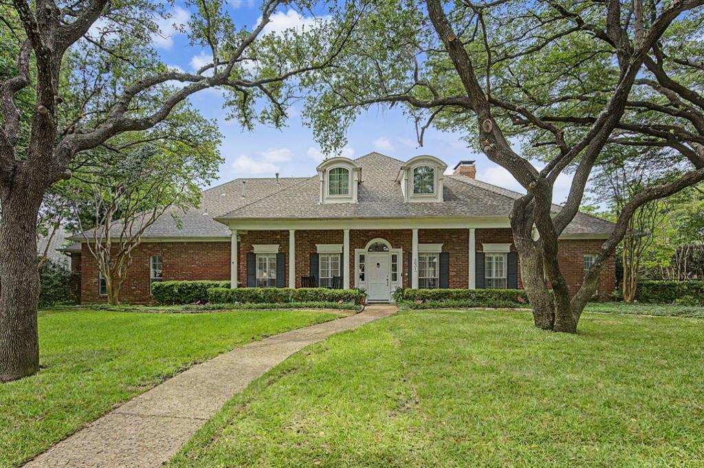 Stately Georgian traditional situated on a beautifully landscaped .30-acre lot in desirable Briar Ridge Estates. A charming red brick exterior and welcoming front porch with rocking chairs create timeless curb appeal. The formal entry opens to an elegant living room anchored by a gas fireplace and flows seamlessly into the formal dining room.

The spacious kitchen features a breakfast area and opens to a private side patio—perfect for enjoying morning coffee. Just off the kitchen, the inviting den offers a wet bar and convenient access to a powder bath, making it ideal for entertaining and poolside gatherings.

The downstairs primary suite is a true retreat, complete with a sitting area, gas fireplace, and en-suite bath featuring dual vanities, separate tub and shower, private water closet, and a spacious walk-in closet. An additional downstairs bedroom is connected to a Jack-and-Jill office, with the office featuring custom built-ins.

Upstairs, a generous landing leads to two oversized bedrooms, each with sitting areas, that share a full bath. A cedar closet provides additional storage.

Designed for both relaxation and entertaining, the backyard features a covered outdoor living area, sparkling pool, mature landscaping, and ample grassy space for play, pets, or gardening.