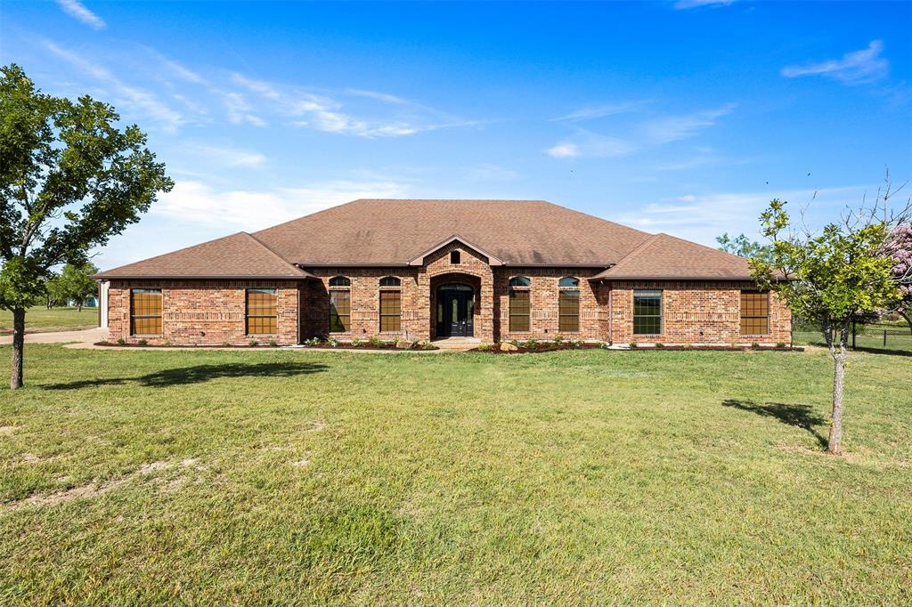 Experience refined country living in this remarkable 3-bedroom, 3-bath residence that perfectly blends timeless elegance with modern luxury. Situated on 5 pristine acres, this estate offers over 3,000 square feet of thoughtfully designed living space, ideal for those who appreciate comfort, privacy, and distinction. Inside, you’ll find soaring ceilings, expansive windows, and impeccable finishes throughout. The home features two spacious living areas that flow seamlessly for both grand entertaining and intimate gatherings. The gourmet kitchen is a chef’s dream—complete with premium appliances, custom cabinetry, an oversized island, and elegant granite countertops. The primary suite is a true sanctuary, showcasing an oversized walk in-shower, stained concrete flooring and attention paid to every detail. Each additional bedroom offers generous space and private access to beautifully appointed bathrooms, ensuring comfort and style for family or guests. A refined office provides the perfect setting for productivity, enhanced by the luxury feel of the rich wood appointed walls and beamed ceilings! Step outside to enjoy the tranquility of your 5-acre property—offering space for outdoor living, potential equestrian use, or simply the luxury of privacy. The covered patio and manicured grounds create the perfect backdrop for morning coffee or evening sunsets. Every detail of this estate has been curated for those who value sophistication, space, and serenity.