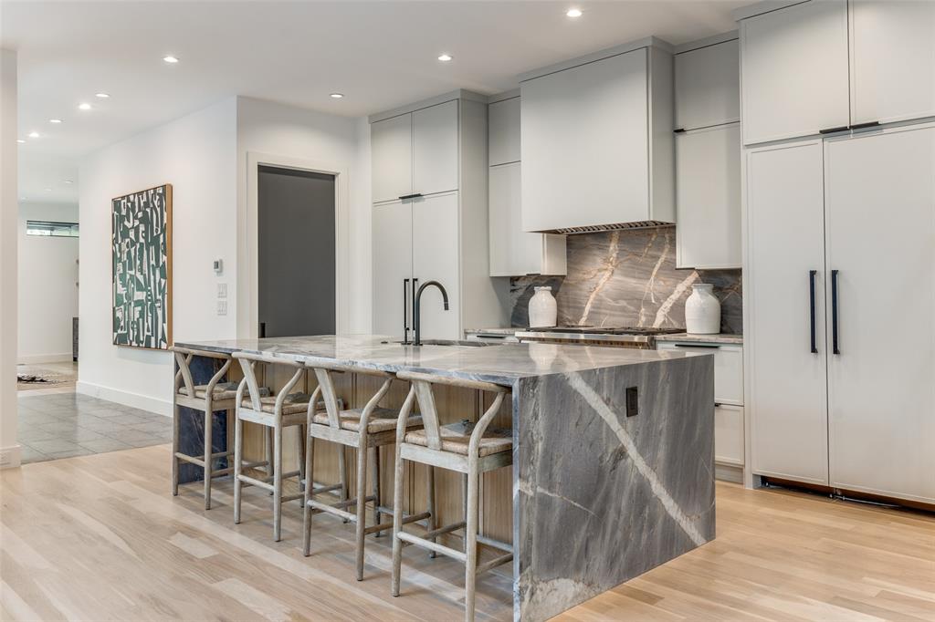 This exquisite 3-level residence offers an unparalleled living experience, conveniently located in Oaklawn across from the Highland Park Fountain. Step inside this meticulously designed home and discover 3 spacious bedrooms and 4.5 bathrooms, each exuding contemporary elegance and sophistication. The interior is bathed in natural light, accentuating the high-end finishes and sleek, modern aesthetic. 

The gourmet kitchen is a culinary haven, featuring top-of-the-line appliances, custom cabinetry, and a generously sized marble island, perfect for both casual dining and entertaining. The open-concept living and dining areas seamlessly blend style and functionality, creating a space that is both inviting and impressive. 

The primary bedroom suite is a private second-floor sanctuary, complete with a lavish en suite bathroom boasting opulent fixtures and ample closet space. Two additional bedrooms on the second floor offer its own en suite bathroom, ensuring comfort and privacy for residents and guests alike. 

Step outside to the private patio and unwind in tranquility, or ascend to the third-floor rooftop terrace to savor panoramic views of the surrounding area, providing the perfect backdrop for relaxation and entertainment. With its premier location and uncompromising luxury, 4214 Hawthorne Avenue offers an unparalleled urban living experience. Indulge in the finest amenities and sophistication that Dallas has to offer in this extraordinary residence with convenient walkability to the shops at Highland Park, and more!