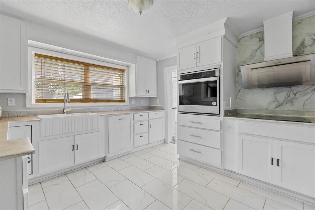 Check out this one percent deal in Clarksville Texas plenty of room to place tiny homes or a mobile home for additional income!  Conveniently located country home just outside of Clarksville on the west side with beautiful mature acreage.  House has been updated with elegance - both the kitchen and the bathroom have modern finishes touches.