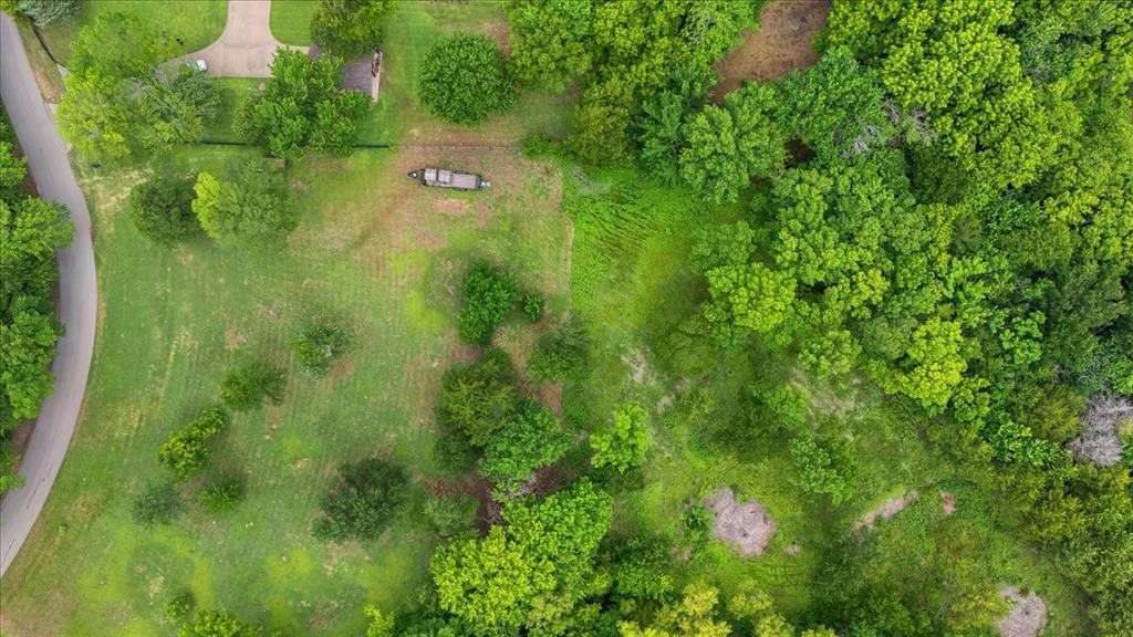 Build your dream home on this beautiful 3.239-acre tract offering the perfect blend of open space and natural beauty. With approximately 484 feet of road frontage on a quiet, low-traffic road, this property provides privacy, tranquility, and plenty of room to create your ideal homesite. The land is partially wooded and partially cleared, giving you flexibility for building while preserving the charm of mature pecan and oak trees throughout the property. A seasonal creek meanders along the back boundary, enhancing the park-like setting and attracting an abundance of wildlife, including wild turkeys and other animals. Enjoy peaceful country living with the convenience of nearby schools, shopping, dining, and everyday amenities. Whether you're ready to build now or planning for the future, this rare acreage offers endless possibilities in a picturesque natural setting.