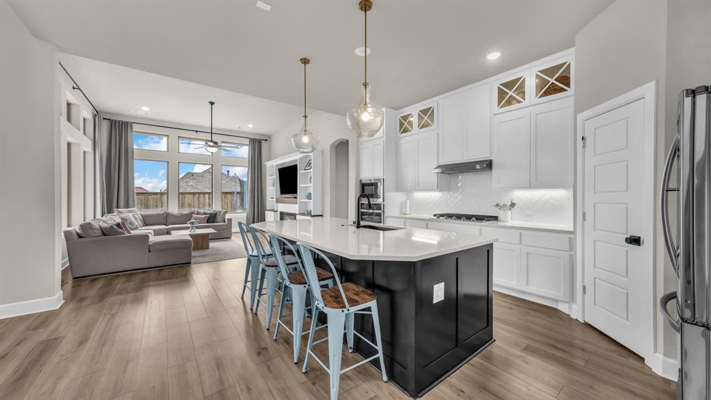 Welcome home to this gorgeous 2-story Pin Oak floor plan by David Weekley Homes, where a striking Tudor-inspired elevation hints at the craftsmanship and character waiting inside. Tucked on a spacious home site just steps from the park, this layout was built for the way real life happens. A coveted downstairs secondary bedroom is ideal for guests or in-laws, and a dedicated home office with custom built-ins gives you a true space to focus and get things done. At the heart of the home, the open-concept kitchen shines with granite countertops, stainless steel appliances, under-cabinet lighting, and an oversized island that flows effortlessly into the family room, perfect for everything from quiet mornings to full house gatherings. Retreat to the spa-inspired Owner's Suite, complete with a luxurious Super Shower, dual vanities, and a generous walk-in closet that feels like a getaway of its own. Upstairs, a media room and game room keep everyone entertained, no matter the age. Outside, your covered back porch is the perfect front row seat for stunning Texas sunsets night after night. And the lifestyle doesn't stop at your front door. Walsh Ranch offers an incredible amenity package including a 10,000 square foot Athletic Club, resort-style pools, tennis and basketball courts, sand volleyball, more than 32 miles of hike and bike trails, a private fishing lake with kayaking, dog parks, a Makerspace, and an on-site Neighborhood Market. HOA fees even include 2 GB high-speed internet and front yard maintenance, so you can spend less time on upkeep and more time enjoying it all. Zoned to the highly acclaimed Aledo ISD with an on-site elementary school, this community truly delivers it all.