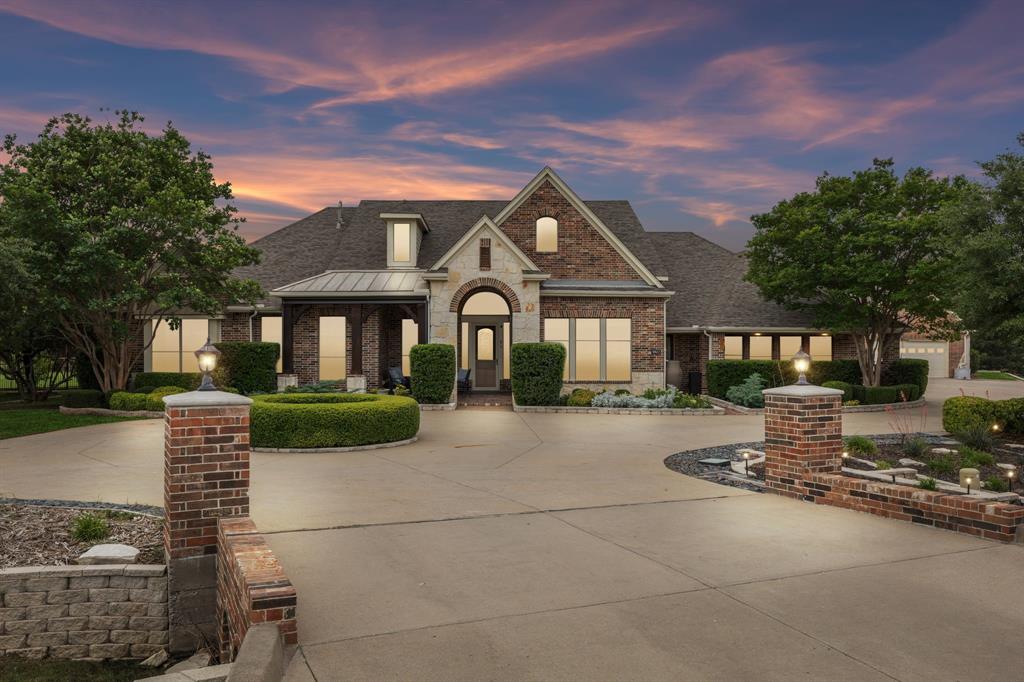 Once-in-a-lifetime opportunity to own a stunning estate in one of North Texas’s premier luxury communities. Perfect for MULTI-GENERATIONAL LIVING, this exceptional Parker home sits on 2.3 acres with a private, park-like backyard and a highly sought-after 1.5-story floorplan featuring all bedrooms downstairs plus expansive upstairs flex space.

Offering 4 bedrooms, 5 garage spaces, and room to grow, this home blends elegance and functionality. Impressive curb appeal includes manicured grounds, circle drive, covered porches, and timeless stone-and-brick exterior. Inside, hand-scraped hardwood floors span much of the main level. The grand entry opens to a formal dining room with tray ceiling, double crown molding, and illuminated art niche. French doors lead to a versatile flex space ideal for a home office or formal living room. PRICED UNDER APPRAISED VALUE!

The inviting family room features a dramatic stone fireplace and flows seamlessly into the chef’s kitchen and casual dining area. The kitchen offers double ovens, oversized island, abundant cabinetry, pull-out shelving, and nearby large utility room with patio access.

The luxurious primary suite includes bay windows, sitting area, spa-inspired bath, and expanded walk-in closet. Secondary bedrooms are downstairs with ensuite or adjacent baths, plus a flexible children’s retreat.

Upstairs features a spacious game-media room with half bath and approximately 900 sq ft of additional flex space perfect for a fifth bedroom, gym, studio, or guest suite.

Additional highlights include extensive storage, insulated attic with lift, dry pantry, 3-car garage plus separate 2-car workshop.

Enjoy energy savings with 64 solar panels and TIGO battery backup, averaging only $41.60 per month in electricity costs. Outdoor living shines with screened and open patios, fully fenced grounds, garden areas, and peaceful sitting spaces.