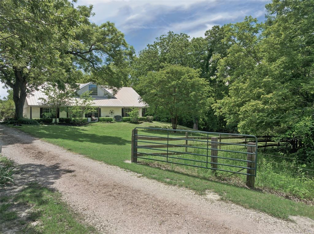 Escape to your own private oasis on 16 stunning, heavily treed acres in the charming community of Van Alstyne. This peaceful 3-bedroom, 2-bathroom home offers the perfect balance of modern comfort and country living, surrounded by hundreds of  mature pecan trees and a serene creek that create a tranquil retreat. A long, tree-lined drive ensures privacy and seclusion, welcoming you to a home designed for both relaxation and connection with nature.

Enjoy quiet mornings on the front porch or peaceful evenings on the spacious back patio, taking in the beauty of the natural landscape. Inside, the open-concept kitchen, dining, and living areas offer a warm and functional space for everyday living and entertaining. The large primary suite features a private bath, generous walk-in closet, and space to truly unwind.

Though nestled in nature, you're just minutes from Van Alstyne's historic downtown, top-rated schools, local shops, and dining, with easy highway access for stress-free commutes. Discover unmatched tranquility and limitless potential on this rare 16-acre AG EXEMPT sanctuary.