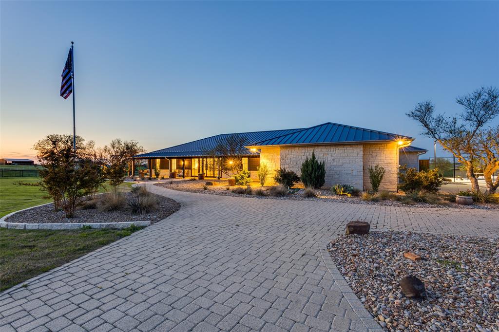Experience the perfect blend of modern luxury and countryside elegance in this stunning ranch-style estate on 11.5 acres, just minutes from downtown Celina. Ideal for ranchers, hobbyists, or professionals seeking a peaceful retreat, this newly remodeled single-story home features a show stopping chef’s kitchen with luxurious countertops, custom cabinetry and Thermador appliances including a steam oven and induction cooktop. The spa-like primary suite offers a cozy fireplace, large walk-in shower and boutique-style closet. Walls of windows blur indoor and outdoor living, while three ensuite bedrooms provide comfort and privacy. Outdoor living exceeds expectations and includes a gorgeous pool and spa overlooking a one-acre pond with lighted fountain, lighted sport court, barns, loafing sheds, cross-fencing, and mini ponds—perfect for livestock and pets alike.  Ag-Exempt and outside the city limits (no city taxes).