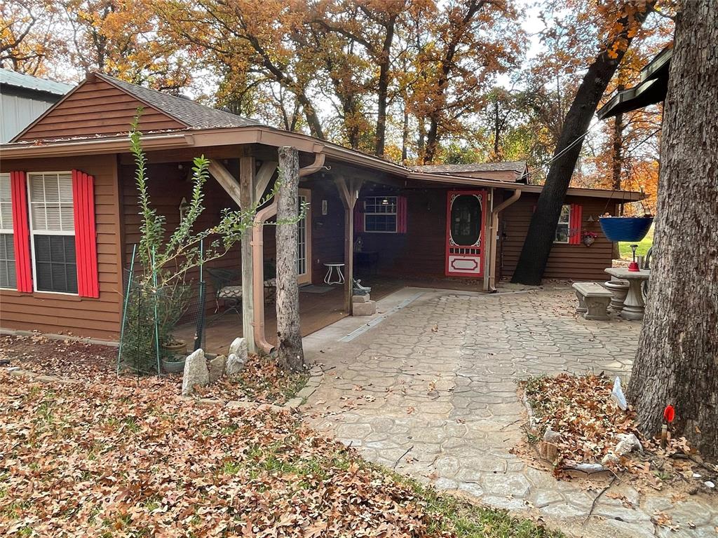 REDUCED! This is THE PRIME SPOT in Lake Granbury RV Ranch! Located at the back of the neighborhood, this home backs up to open space and has ample space and land for that secluded feel! VERY CUTE 1 BD - 1 BA home with a nice size kitchen with granite countertops, and a spacious living area! The bedroom is large, with a large closet. And the laundry room has extra space for storage! Fridge and WD stay! There is a very nice, large patio area great for entertaining or just enjoying the outdoors! The RV carport is 95' long, 15' wide, and 13' tall. Includes a workshop with electric! The storm shelter is shared with a neighbor. Everything is in very good condition, and the location is amazing! Cash or conventional only. $20 monthly assessment in addition to dues.