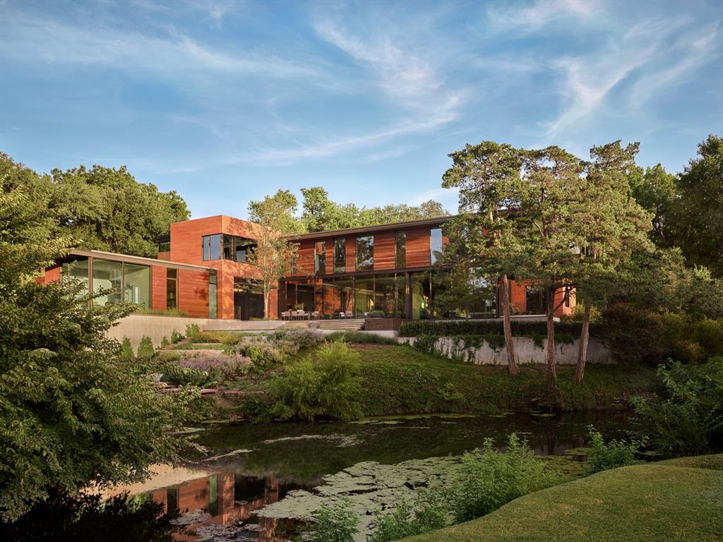 Located on one of HP's most desirable locations, at the end of a quiet street, with the serene creek on is western boundary sits this incredible Larry Speck designed estate constructed with walls of glass showcasing the views of the Dallas Country Club golf course and surrounding nature. The light-filled first level has a wonderful flow for everyday living and entertaining with the living and dining rooms on either side of the foyer, the living room leading to the study and the dining room sharing a dual sided fireplace with the family room. The family room is open to the breakfast room, kitchen and wet bar. A playroom and full guest quarters complete the main level along with an elevator. The second floor boast the spacious master suite with office area, two additional bedrooms and bathrooms and a family room. Exceptional outdoor entertaining with an outdoor cooking area and several porches and verandas all with views of the creek and golf course.