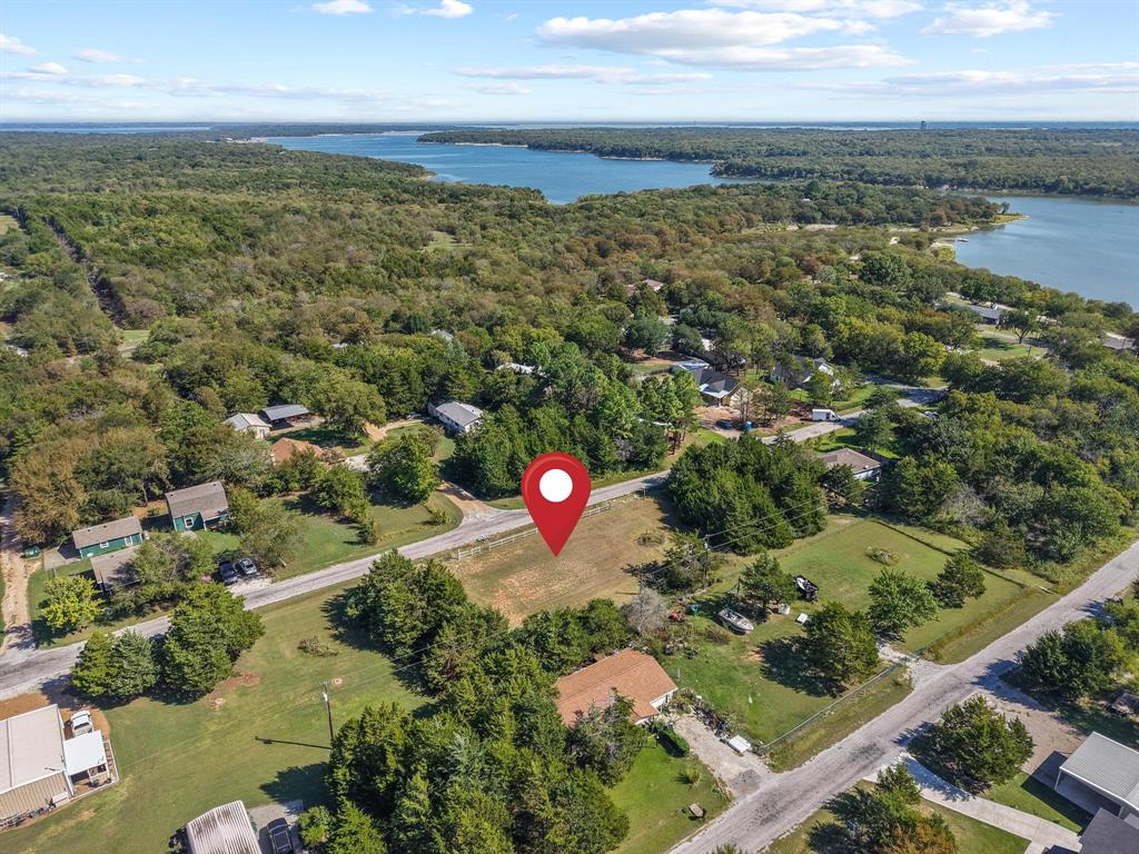 Ready to build your lake retreat? These 4 combined lots (totaling .45 acres) in the Simmons Shores community are prepped and waiting. The property already includes electric and water connections, two driveways with culverts, and a sturdy metal fence along the front. Simmons Shores offers fantastic amenities including a community pool, boat launch, and fishing pier for its members. Conveniently located just a short drive to Highport Marina and Tanglewood Resort, where you’ll enjoy dining, golf, boat slips, and more. With short-term rentals allowed, this property is not only perfect for your personal getaway but also a smart investment opportunity.