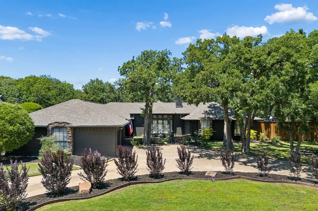 Situated on a premium oversized lot on the 3rd hole of the Hogan Course at Trophy Club Country Club, this updated single-story home offers the perfect blend of style, comfort, and location. Features include a welcoming circle drive, two very large living areas, vaulted ceilings with exposed beams, designer updates throughout, and a beautiful primary retreat. Enjoy year-round entertaining with a covered outdoor living pavilion, fire pit area, and an oversized backyard shaded by mature trees. Rare golf course setting in one of Trophy Club's most desirable locations with incredible indoor-outdoor living and picturesque views. Just a quick golf cart ride to many restaurants, shops, parks, and the country club. A flexible plan perfect any buyer looking for the character and functionality of a ranch-style retreat. No HOA allows you to expand your vision on this amazing home and make it yours.