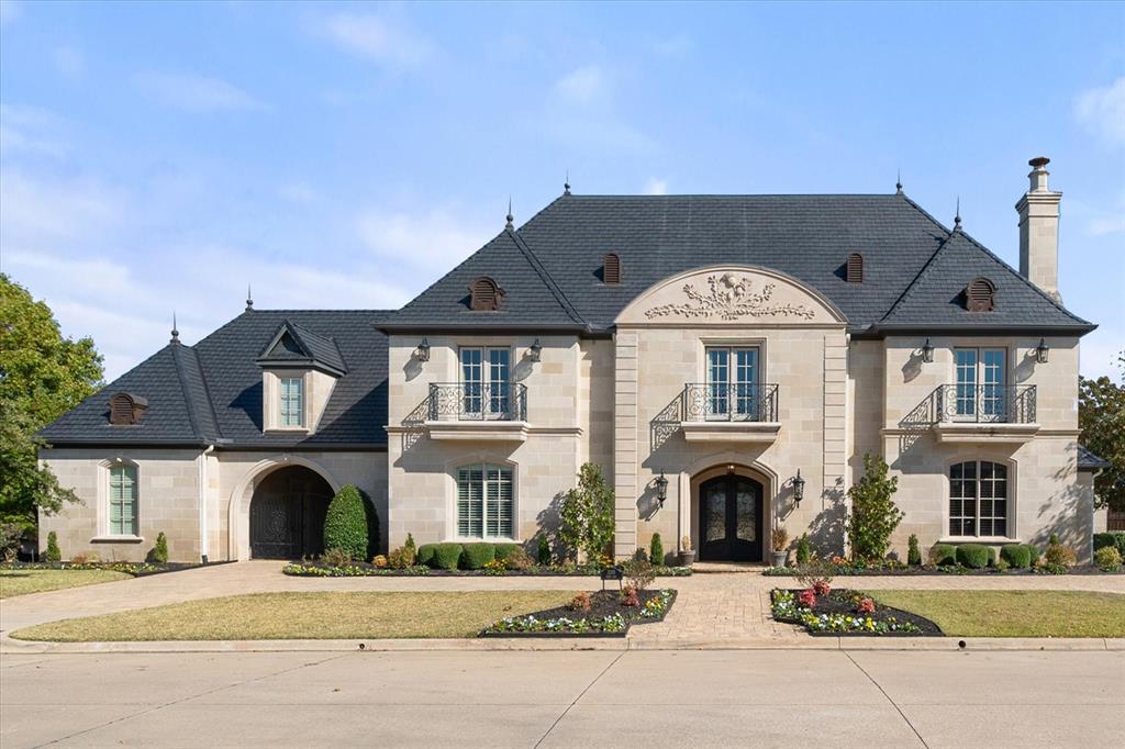 Nestled on nearly three-quarters of an acre in Mansfield's prestigious Strawberry Fields, this stunning estate spans an impressive 8,585 square feet. It features 5 bedrooms, 7 full baths, and 2 half baths, showcasing unparalleled luxury and thoughtful design. As you step inside, you're greeted by an elegant and grand ambiance. The home offers two master suites, each serving as a private retreat. The downstairs master suite includes French doors that open to the pool area for seamless indoor-outdoor living. It also features a coffee bar, dual closets, dual sinks, a walk-in shower, and a luxurious jetted tub. Upstairs, the second master suite boasts a spectacular bathroom and breathtaking views of the outdoor spaces. This estate includes two versatile offices, one equipped with a fireplace and a tornado shelter, and the other with built-ins and a full bath, offering the potential to serve as a sixth bedroom. Throughout the home, the exquisite finishes and meticulous craftsmanship elevate every corner. The kitchen is a chef's dream, equipped with a 5-burner gas cooktop, a new built-in refrigerator, microwave, dishwasher, and an expansive walk-in pantry. The living area is designed for both comfort and entertainment, with large glass doors that seamlessly merge indoor and outdoor spaces. The outdoor area is a true paradise, perfect for entertaining or relaxing. It includes a custom negative-edge pool with fountain features, a tiled spa, an in-pool granite table with seating, and a spacious sun deck. The cabana and two patios, each with a fireplace—one also equipped with an outdoor kitchen—enhance the space's versatility and charm. Other amenities include an elevator, a game room, updated HVAC units, fresh paint, exterior coach lights, and a new custom Davinci RoofScape roof. The estate offers ample parking with a 3-car garage featuring a fully floored attic and a separate 1-car garage with HVAC. The gated driveway provides added security and plenty of parking space.