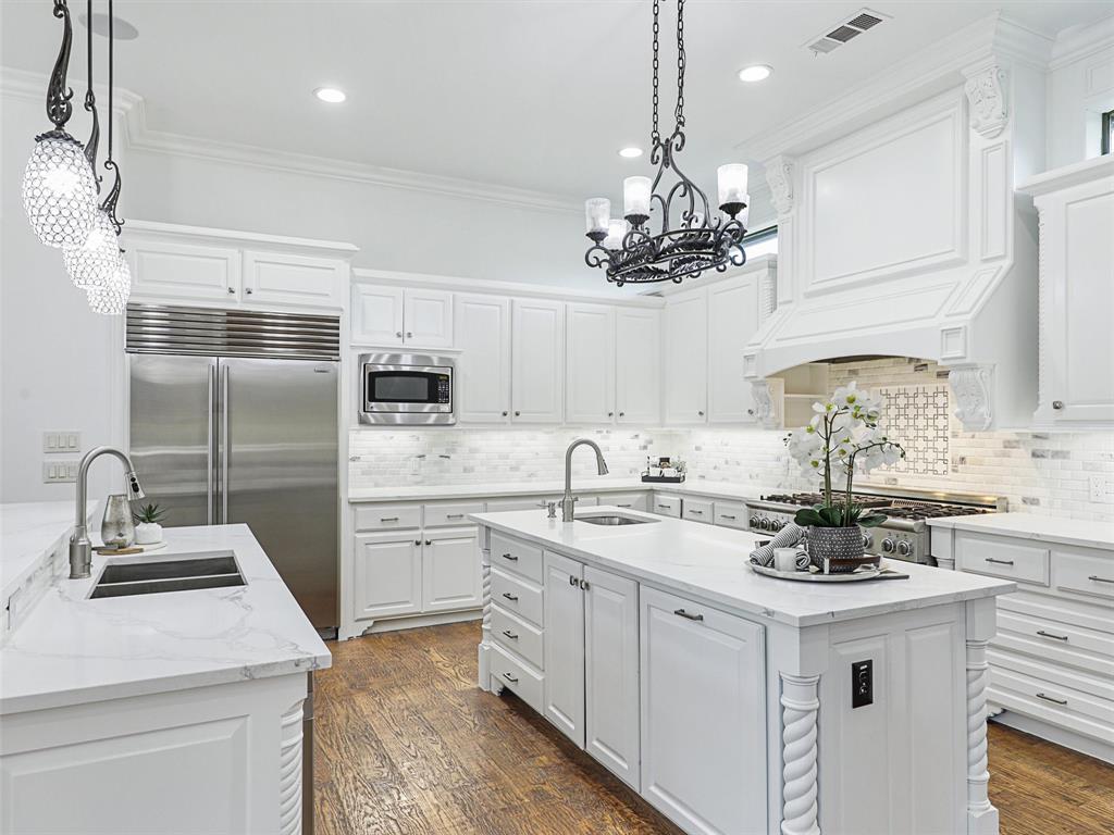 Freshly Painted, White & Bright interior!  Move in ready!!!  Welcome Home to this gorgeous, custom home in Sandlin Manor with the Backyard Oasis of your dreams! Ready for fun, this home boasts a spacious private backyard with large sparkling pool, water features, spa, new landscaping, covered outdoor kitchen, multiple sitting areas, new privacy fence + tons of grass for kids & pets to play. Park on the circular drive & enter to soaring ceilings, custom millwork, wood floors, open floor plan + perfect views to the lovely backyard. Beautiful Formals with fireplace + sep Wine Room lead to Great Room. Updated White Kitchen with 2 islands, comm appliances, Breakfast area overlooking the pool + large Family with soaring fireplace. Adjacent Media Room has Wet Bar for entertaining. Executive Study, private Primary suite w spa bath + huge closet, and Guest suite are down. Upstairs boasts 3 bedrooms, Game room with wet bar, large Bonus-Exercise room + study area. 4 car garage + driveway gate.