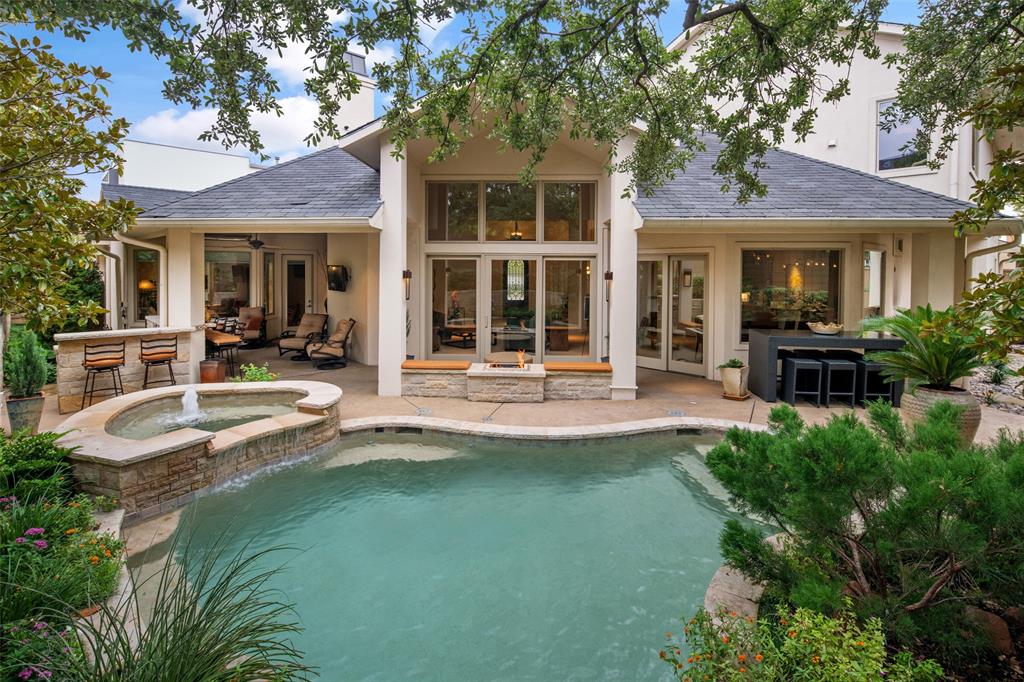 Extraordinary transitional modern home located in a very exclusive private gated, ten home neighborhood with views of lakes and fountains. Unique corner lot home designed for living and entertaining. The grand entrance foyer, dining room, designer kitchen, large living area and wine tasting room open to the extremely private outdoor covered terrace, pool and spa. Other fabulous features on the first floor include the beautiful owners suite, a guest room-study and a media-playroom. Upstairs includes a loft area, two bedrooms, a cozy family room with bar and fireplace. This home is tucked away in the back, secluded and safe, with picturesque views of magnolias, live oaks, and landscaping. A very special home!