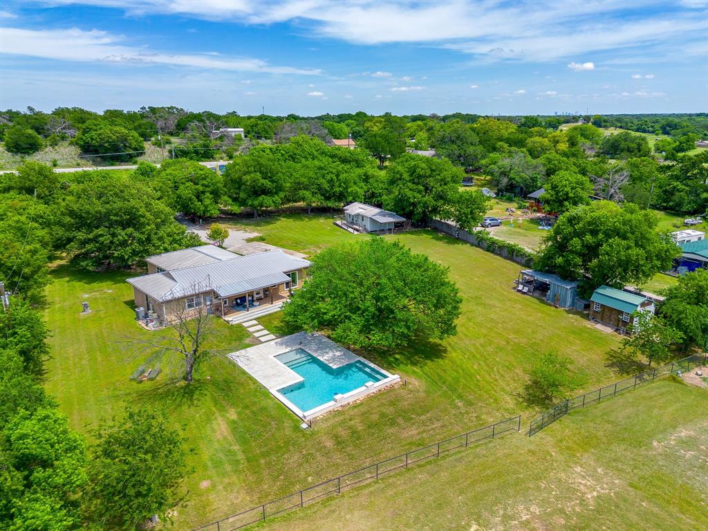 10 Acres + POOL + Guest House + Gorgeous Texas sunsets!! This beautifully preserved 1940s bungalow, originally moved from Camp Bowie, is truly magical and comes with it's own rich history. 

The home has just received a full interior paint refresh and features new white oak luxury vinyl plank flooring throughout, giving it a clean, updated feel while maintaining its original character. The updated kitchen offers both style and function, making it ideal for everyday living and entertaining.

Situated on 10 STUNNING acres, this property is the backdrop every Texan wants. Located outside city limits, this home offers the freedom of country living with unbeatable convenience—just 15 minutes from downtown Fort Worth. 

Inside, the home features 3 bedrooms, 2 bathrooms, a dedicated office, and an oversized living room perfect for gathering. Step outside to your private retreat, where a gorgeous pool sits amongst hundred year oaks and a natural creek at the back of the property.

The opportunities here are endless with a fully equipped 400 sq ft guest house—complete with its own fenced yard—ideal for multi-generational living, guests, or income-producing rental potential. The entire property is secured with piped fencing and includes a steel shipping container, along with a 300 sq ft workshop featuring two workbenches and a loft for added storage or workspace.

Both homes are equipped with water filtration systems for added comfort and quality.

This is a rare find where charm meets country life. Come see for yourself, hang your hat and stay a while!