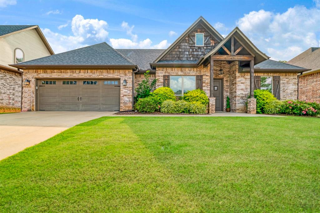Welcome to this beautifully crafted custom home where timeless style meets modern comfort. From the moment you arrive, you'll be captivated by the exceptional curb appeal featuring charming wood accents, professional landscaping, and an inviting front porch that sets the tone for everything inside. Step through the front door into an expansive open-concept floor plan designed for both everyday living and effortless entertaining. The spacious living room is anchored by a stunning floor-to-ceiling brick fireplace with a rustic wood mantel, while large windows fill the home with natural light and showcase views of the beautifully landscaped backyard.
The chef-inspired kitchen is the true centerpiece of the home, offering custom cabinetry that extends to the ceiling, elegant granite countertops, stainless steel appliances, designer lighting, a large center island with bar seating, subway tile backsplash, and a walk-in pantry. The adjoining breakfast area and formal dining room provide flexible spaces for family meals, holidays, and entertaining guests.
The private primary suite is a relaxing retreat featuring a spa-like ensuite complete with dual granite vanities, a luxurious soaking tub, oversized walk-in tiled shower, private water closet, and generous walk-in closet. Spacious secondary bedrooms offer high ceilings, abundant natural light, and ample closet space to comfortably accommodate family and guests.
Step outside to your own backyard oasis where an extended covered patio is enhanced by a beautiful cedar pergola with café lighting, creating the perfect space for outdoor dining, weekend barbecues, or relaxing evenings. The fully fenced backyard offers lush landscaping, decorative rock borders, and plenty of room for children, pets, or future outdoor additions.
Combining quality craftsmanship, functional design, and exceptional outdoor living, this move-in-ready home offers everything today's buyers are looking for and is ready to welcome its next owners home.