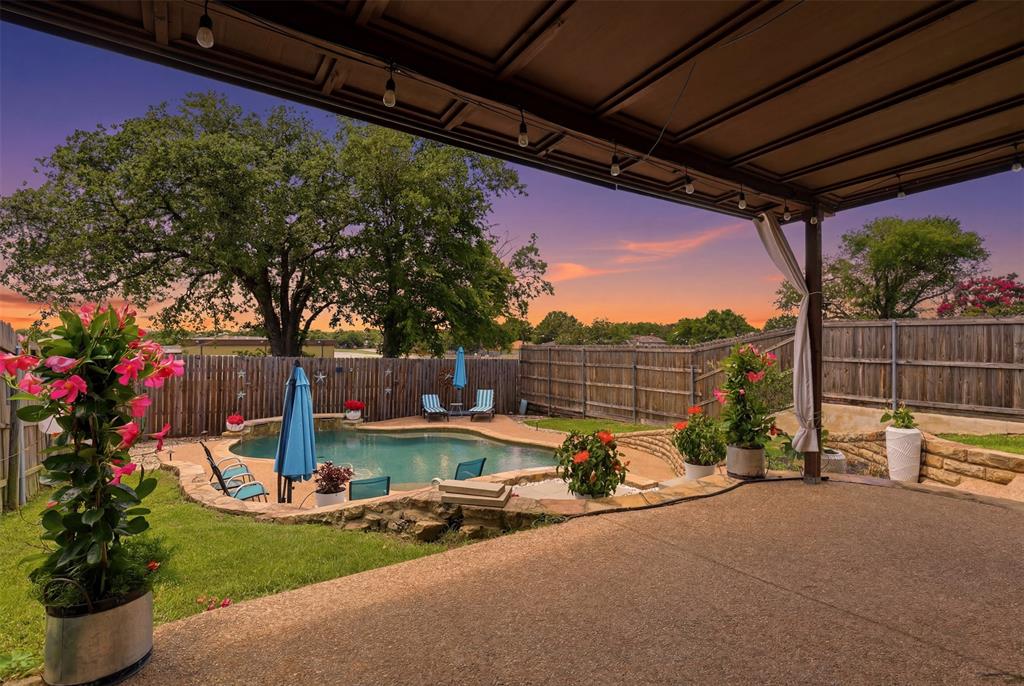Private pool side sanctuary in the heart of Bedford, where a sparkling pool, soothing water feature, and 8 foot tall privacy fencing create the perfect setting for relaxing, entertaining, and making lasting memories. Beautifully updated and move-in ready, this 3-bedroom, 2.5-bath home offers 1,901 square feet of thoughtfully designed living space filled with character and charm.

A blend of vaulted, tray, and traditional ceilings, decorative lighting, and skylights create architectural interest throughout. Open floor plan flows into an updated kitchen featuring granite countertops, white painted cabinetry, designer backsplash, modern hardware, an under-mount sink. A versatile flex space can serve as a formal dining room or home office.

The primary suite offers tray ceiling and an ensuite bath featuring an extended granite countertop, dual sinks with separate mirrors, a garden soaking tub, and separate shower. A climate-controlled sunroom overlooking the backyard adds valuable living space year-round. The premium Renewal by Andersen sliding glass door installed in 2025 fills the room with sunshine while maintaining energy efficiency and comfort.

Step outside and discover the true centerpiece of the home. Whether you're cooling off in the pool on a warm Texas afternoon, hosting weekend cookouts with friends, or enjoying a quiet evening under the stars, this backyard was designed to be enjoyed. The combination of privacy, outdoor living, and mature neighborhood charm creates a setting that's becoming increasingly difficult to find.

Major updates include, new skylights, HVAC replaced in 2024, pool pump and valves replaced in February 2026 with high end remote monitoring capabilities; 5 year old roof and security cameras.  Conveniently located near shopping, dining, parks, trails, Highway 121, Highway 183, and DFW International Airport, this exceptional Bedford home offers the perfect blend of comfort, convenience, and outdoor living.