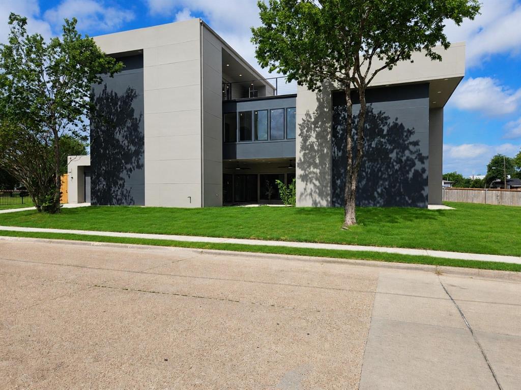 Architectural sophistication meets modern luxury in this exceptional contemporary residence, perfectly positioned on a premier corner lot in the heart of Trinity Groves, one of Dallas fastest growing and most sought after neighborhoods. Just minutes from Downtown Dallas, the Design District, Bishop Arts, and premier dining and entertainment, this home offers the ultimate urban lifestyle. Offering approximately 3,200 square feet, this stunning three story home features 4 bedrooms, 3.5 bathrooms, a versatile third floor flex room with a wet bar, and a 2 car garage. Step inside to soaring ceilings, dramatic two story living spaces, walls of glass, and an abundance of natural light surrounding a tranquil interior courtyard. The open concept layout is ideal for both everyday living and entertaining. The chef's kitchen showcases custom flat panel cabinetry, premium stainless steel appliances, designer lighting, and an oversized waterfall island. An elevated dining area overlooks the main living space, further enhancing the home's striking architectural appeal. The luxurious primary suite features a sleek linear fireplace, private courtyard access, and a spa inspired ensuite complete with dual rain shower heads, a freestanding soaking tub, dual vessel vanities, and an expansive walk in closet with custom built in shelving. The spacious third floor area features a wet bar and fireplace, creating the perfect setting for entertaining, relaxing, or hosting guests. Enjoy a covered patio, private backyard, and beautifully landscaped courtyard, offering multiple outdoor spaces to unwind year round. The crown jewel of the home is the expansive rooftop deck, showcasing breathtaking Downtown Dallas skyline views and unforgettable Texas sunsets, creating the ultimate space for entertaining or relaxing above the city.With bold contemporary architecture, designer finishes, and an unbeatable location, this exceptional residence delivers an elevated lifestyle.