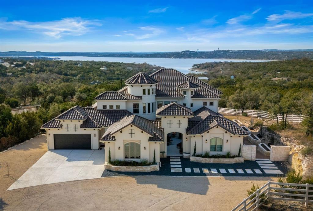 Owner financing available for qualified buyers. 

Private, gated 10 plus or minus acre estate at the end of the road and backing to the Balcones Canyonlands, this property offers views of Lake Travis & the surrounding Hill Country with privacy just minutes from lake access. The thoughtfully designed compound includes a 4,744 plus or minus sq ft custom main residence, a 2,60 plus or minus sq ft guest house, & premier equestrian facilities, all oriented to capture the protected natural landscape. The main residence features dramatic two-story windows, multiple indoor & outdoor living areas, a two-sided stone fireplace, and expansive covered and uncovered patios with an outdoor kitchen and fireplace, ideal for entertaining & sunset views. The primary suite offers a spa-like bath with copper sinks, soaking tub, walk-in shower, & custom closet. A chef’s kitchen with a Bertazzoni range, custom cabinetry, butler’s pantry, office, media room, and additional living spaces complete the home. The guest house includes a private courtyard with cooking center, flexible bedroom and office spaces, porcelain tile floors, & an upstairs apartment with private entrance and preserve views. Equestrian amenities include a ~2,000 sq ft six-stall barn with smart-controlled water systems, indoor and outdoor wash racks, tack room with bath, and a second-floor one-bedroom apartment with balcony, plus a riding arena and two fenced pastures. The barn offers versatility and could be reimagined to support a variety of hobbies from a party barn for entertaining, to a toy barn, or a private workshop, gym, or creative studio. Located about 20 minutes from the iconic Pennybacker Bridge, the property offers preserve frontage, approximately one mile of trails, multiple dwellings, & turnkey horse facilities, ideal for a private estate, equestrian operation, or family compound, all while remaining just 10 minutes from the Four Points area & about 30 minutes to downtown Austin.