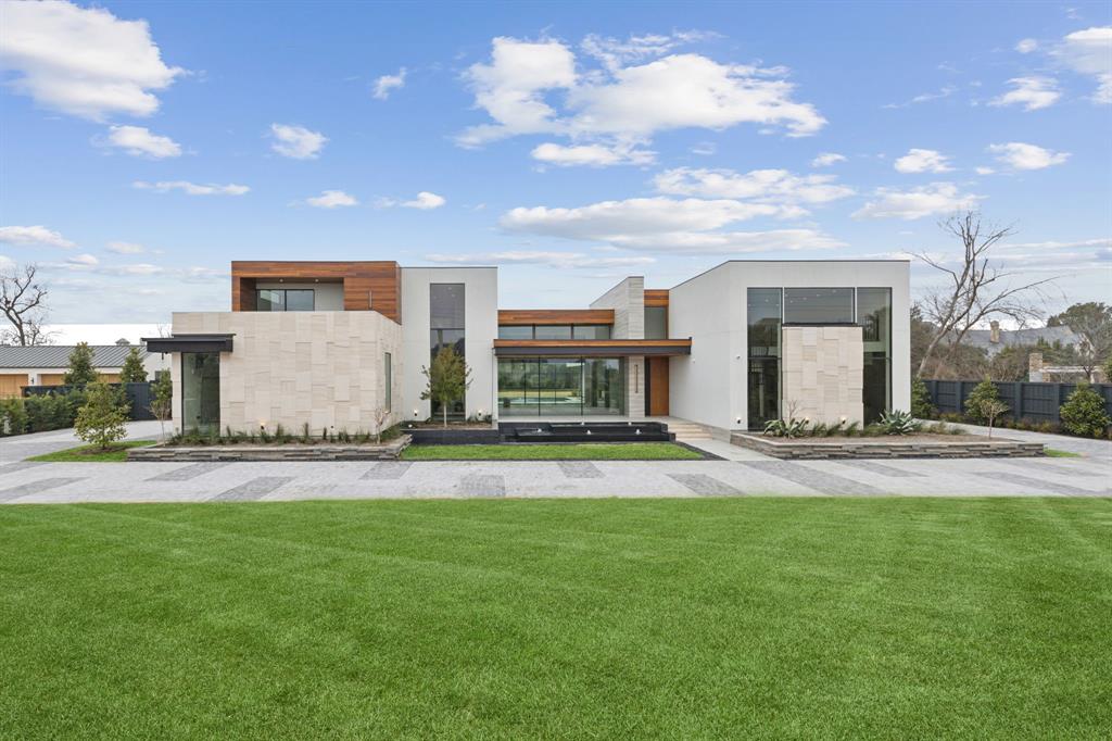 Nestled within a prestigious Preston Hollow enclave in Dallas and guarded by a sculptural metal gate, this new construction contemporary estate by Atrium Fine Homes is perfectly positioned on a sprawling 0.952-acre lot. 

With 11,824 square feet, this stunning residence offers 5 spacious bedrooms in the main house, 6.2 baths, 4 living areas, 2 dining areas, a main kitchen with exotic backlit stonework, prep kitchen, an impressive two-story formal study with spiral staircase, an elevator, large laundry-mud room, and garage parking for 5 automobiles.

The open floor plan features soaring ceilings, 97 oversized windows and doors, and tons of natural light. This sophisticated sanctuary utilizes the finest materials and highest-end finishes such as Overture Cadenza Brazilian Oak flooring, Cumaru wood paneling, custom Poliform cabinetry from Italy, Awake windows and slider doors, Wolf-Subzero-Miele appliances, and exotic stonework imported from six countries - Italy, Brazil, Argentina, Portugal, Spain, and Israel. Quality craftsmanship completely encapsulate the home, including the soothing front water feature, multiple balconies, exterior cut stone from Portugal designed specifically for the home, tall ceilings and disappearing sliding glass pocket doors, and the sculptural main  staircase which doubles as an exquisite work of art. 

The owner’s suite has its own wing of the main floor, complete with a breathtaking White Patagonia stone fireplace from Argentina and a sumptuous Caldia Marble bath with dual vanities, dual water closets, a walk-in shower, private outdoor shower area, and a huge custom closet with laundry room and panic room-storm shelter.

Comfortable living continues outdoors with a covered living area, steel trellis with lighting, summer kitchen, a cabana-exercise room-6th bedroom-bonus space with full bath and kitchenette, an outdoor staircase, and a turfed upper deck area-entertainment space overlooking the expansive grassy back yard.