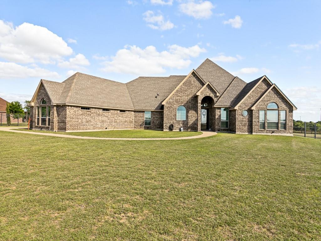 Welcome to Panther Estates! Spacious one story custom brick home with four bedrooms, 3 full baths sitting on an acre lot. One owner home with an open floor plan and split bedrooms. Kitchen features custom knotty alder wood cabinets, stainless appliances, two islands and walk-in pantry. Kitchen opens to the dining and living room with a stone fireplace. Large primary bedroom with sitting area, separate shower, sunken soaking tub, dual vanities and walk-in closet. Mother-in-law suite or guest bedroom ensuite currently used as second office-den. Generously sized secondary bedrooms with walk-in closets. Scored concrete flooring and tile through out. Office area with built-in desk and cabinets. Separate full size utility room with custom cabinets, folding area and hang dry area. Oversized 3 car garage with plenty of storage. Covered patio with outdoor fireplace. Fully fenced backyard with plenty of room for RV parking, boat parking, playground or room to build a pool. Propane tank owned and buried, used for tankless water heaters, gas stove and gas assist. Solar panels owned and convey with the sale of the home. Quiet neighborhood. Close to shopping, schools and highways. Minutes to downtown Fort Worth with the Chisholm Trail Parkway down the road. A must see!!!