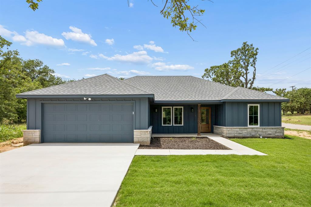 New build without the HOA, PID or MUD on DOUBLE LOT! Welcome to the perfect blend of modern style, thoughtful design, and small-town charm in the heart of Mineral Wells. This brand-new single-story home offers an open-concept layout filled with natural light, durable wood-look flooring throughout, and custom finishes that set it apart from typical new construction.

The spacious living room flows seamlessly into the stunning kitchen, featuring rich custom cabinetry, quartz countertops, stainless steel appliances, a large center island, and abundant storage. Whether you're hosting friends or enjoying a quiet evening at home, this layout was designed for everyday living and effortless entertaining. Energy efficient spray foam insulation throughout attic!

Retreat to the private primary suite, complete with a spa-inspired bathroom featuring dual vanities, an oversized walk-in tiled shower, a separate water closet, and an impressive walk-in closet with built-in drawer storage. The secondary bedrooms are generously sized and share a beautifully appointed bathroom showcasing designer tile work and modern fixtures.

Thoughtful details continue throughout the home, including a dedicated mudroom-drop zone, spacious laundry room with sink, modern black hardware and fixtures, and ample storage solutions throughout.

Outside, you'll enjoy mature oak trees, fresh landscaping, a large backyard with plenty of room for outdoor living, and the peaceful atmosphere that makes Mineral Wells so desirable. With its custom-home feel, quality finishes, and move-in ready condition, this home offers a rare opportunity to enjoy brand-new construction without sacrificing character or charm.

Why settle for builder-grade when you can have custom-inspired design, modern finishes, and a home that truly stands out? Welcome home.