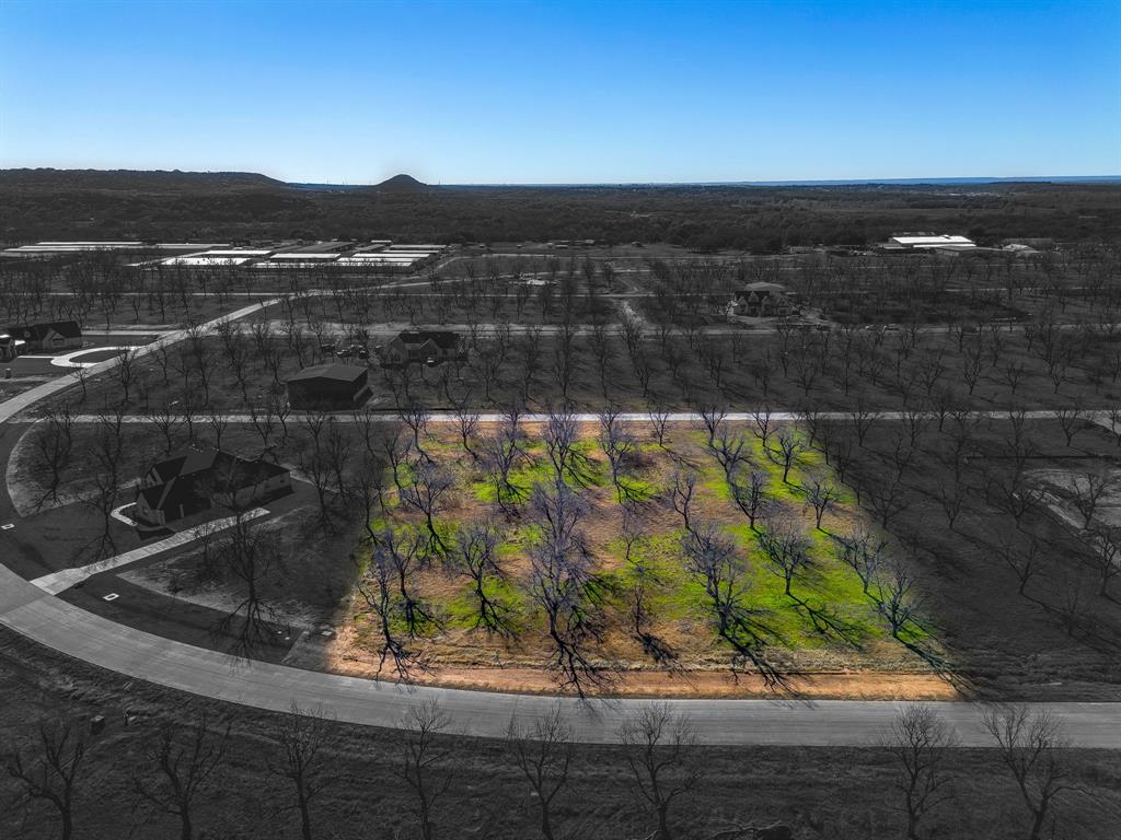 Howdy! Welcome to The Landings East at Pecan Plantation, the LARGEST Airpark in the State of Texas and the 3rd LARGEST in the US! Direct access to the Taxiway. LOT 3916, 1449 Cirrus Loop, 1.5 acres. LOT dim 193 x 325 x 194 x 346 Site is complete with paved roads, electric service, MUD water, MUD sewer. Orchard irrigation & high speed internet available. Min SQFT to build is 2,000. No time frame to build. Hangars may be constructed with residence but not built prior to construction of home. FAA Identifier: 66TE PPOA Discover the exceptional lifestyle of Pecan Plantation, a private, gated community nestled along 17 miles of the historic Brazos River within a 4,200 acre pecan orchard. Enjoy resort style amenities including two championship golf courses with full practice facilities, a full-service clubhouse with multiple dining options, marina with access to Lake Granbury, tennis & pickleball courts, pools, dog park, riverside parks, Airparks, camping, & 24 7 security with Fire & EMS services. The Village, features a bank, grocery store, restaurant, Pecan Medical Clinic, PT Services, pharmacy, golf cart shop, Vet Clinic, car wash, & Ace Hardware. Just minutes from the Historic Granbury Square officially the “Celebration Capital of Texas” under an hour from Fort Worth. Experience the perfect blend of tranquility, recreation, and convenience. Come see why you’ll want to build your dream home here! PPOA Mandatory Membership as of 9-1-25: PPOA Transfer Fee $1,091.00 + 73.65 (tax) = $1,304.49. Initiation Fee $4,381 EQUALS: $5,545.65 The monthly fee is $204.75 and includes trash service or $182.75 without trash service. Search YouTube 'Airplane Ride Around Pecan Plantation Rebecca Van Buren' to learn about our amazing community.